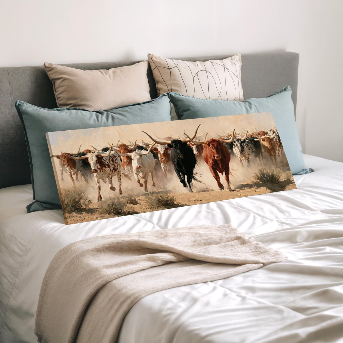 Longhorn cattle stampede wide panoramic canvas print laid on a bed to show its size