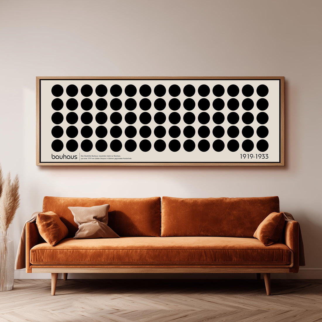 a modern living room with a black and white checkered sofa, a stack of books, and a large abstract art piece on the wall.