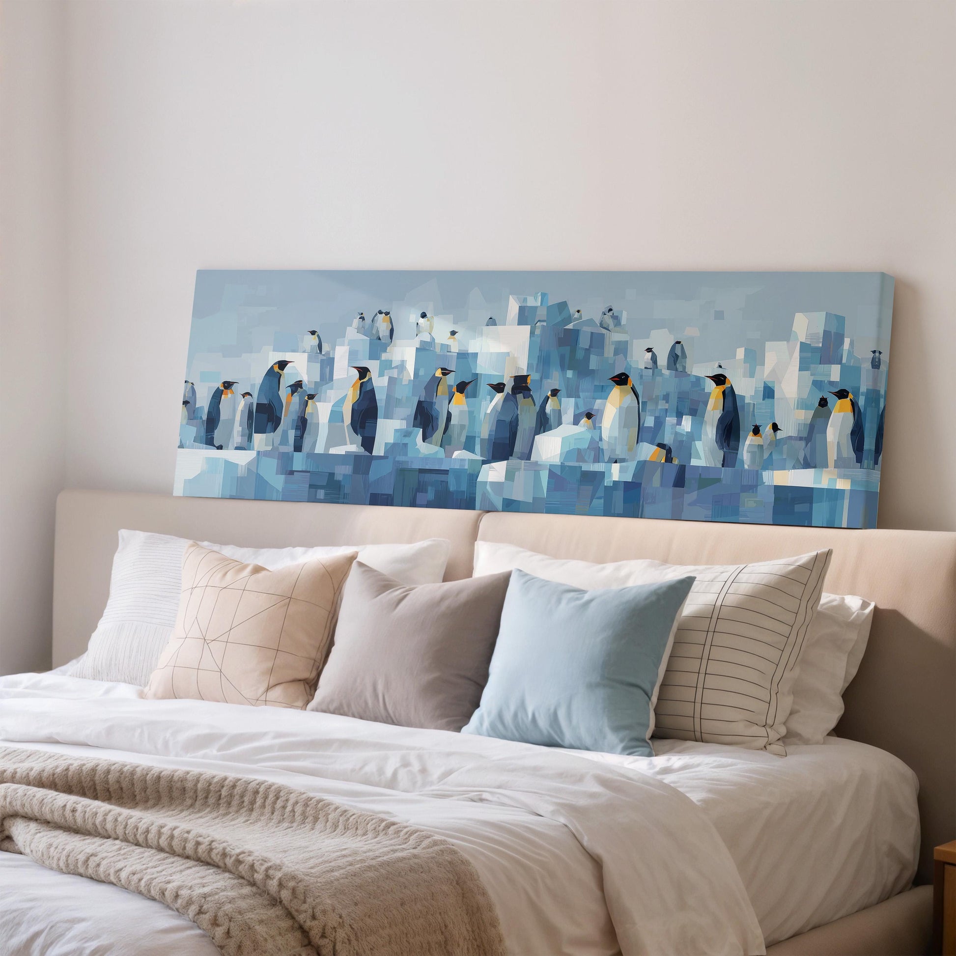 a large painting of penguins on a wall above a bed with white pillows and a gray blanket.