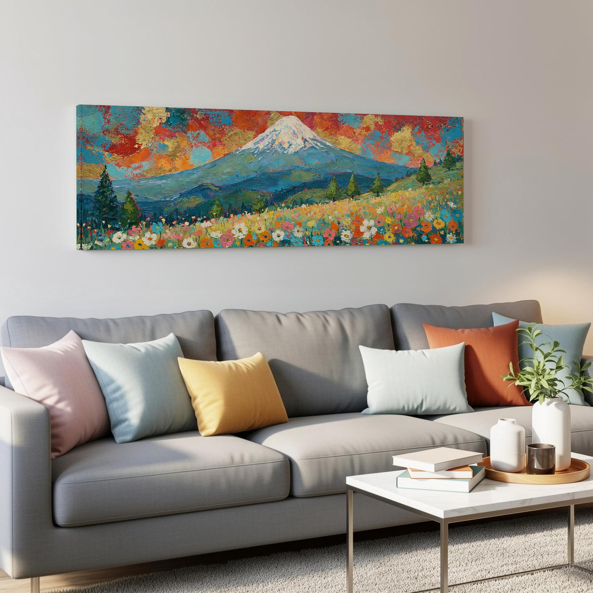 Mount Fuji under a red and gold sunset sky panoramic canvas print above a grey sofa in a living room