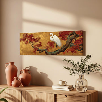 a wooden cabinet with a painting of a white heron perched on a branch, a vase with greenery, and a stack of books.