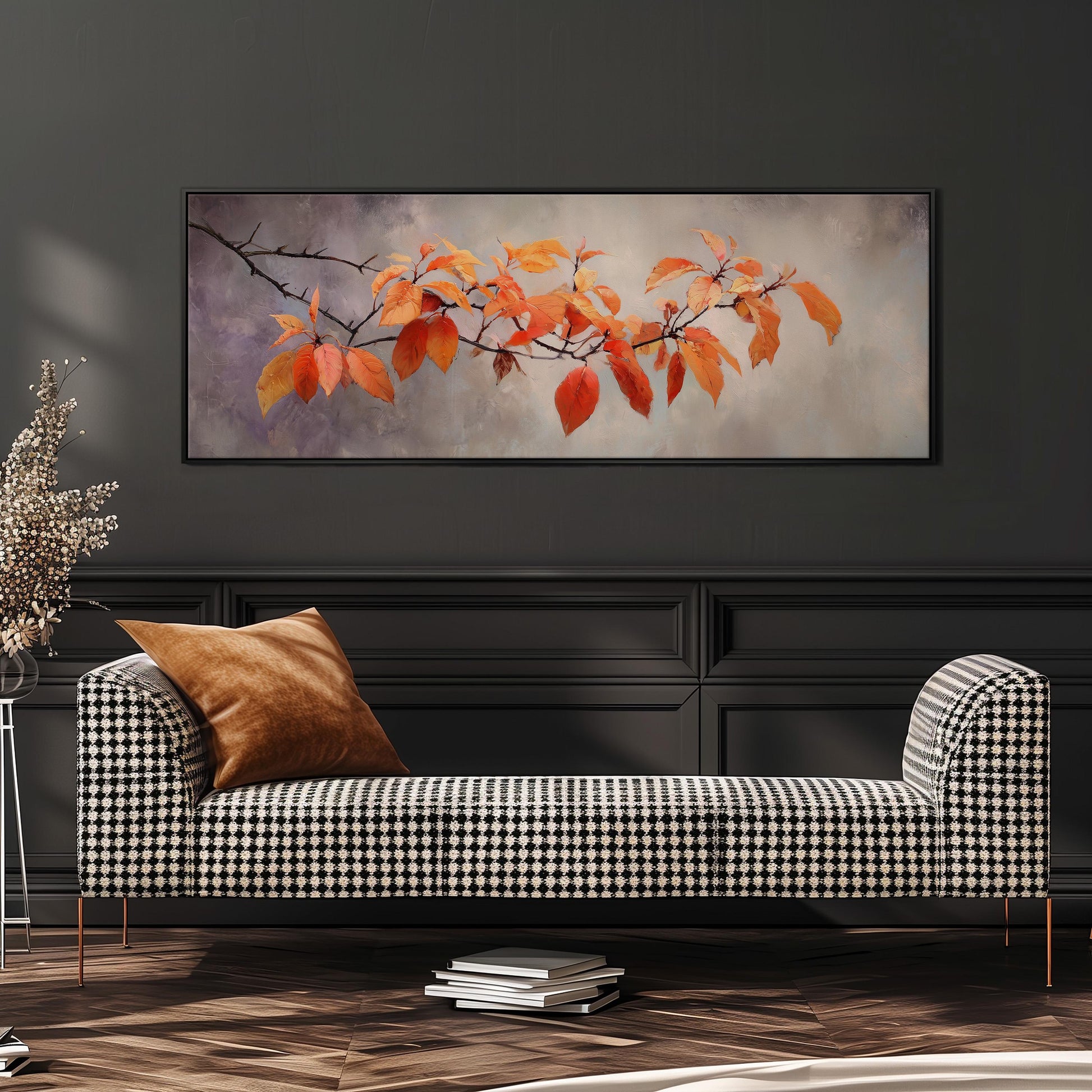 a black and white checkered sofa with a brown throw pillow, set against a dark wall with a framed painting of orange leaves hanging above it.