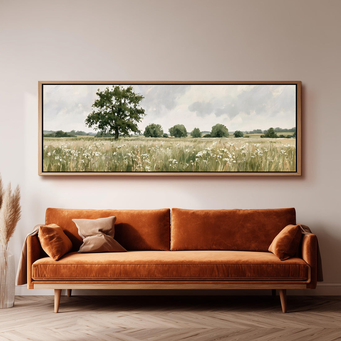 Lone oak tree in a daisy meadow long horizontal canvas print above a sofa in a living room