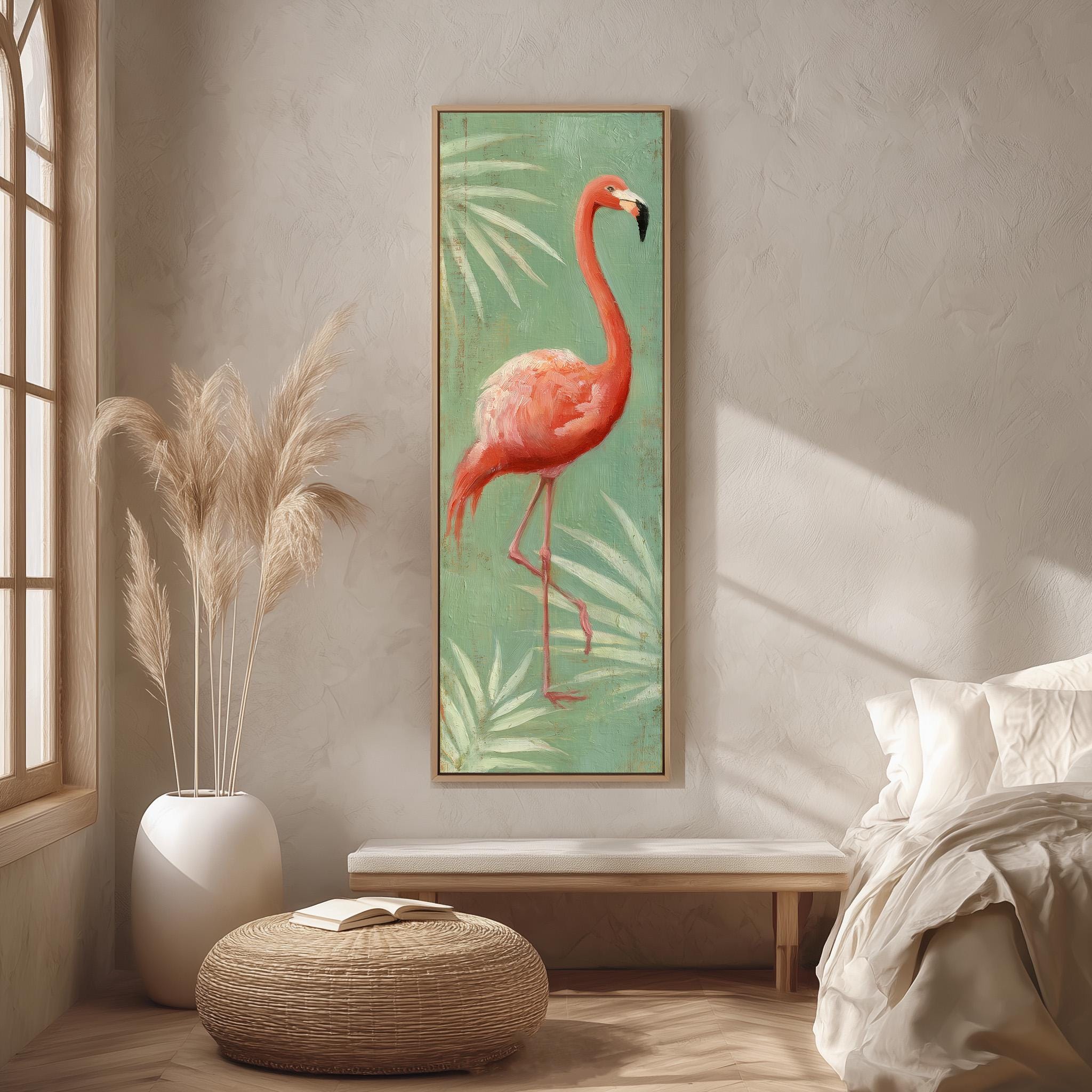 a large framed painting of a flamingo standing on one leg, hanging on a wall in a room with a bed, a potted plant, and a woven ottoman.
