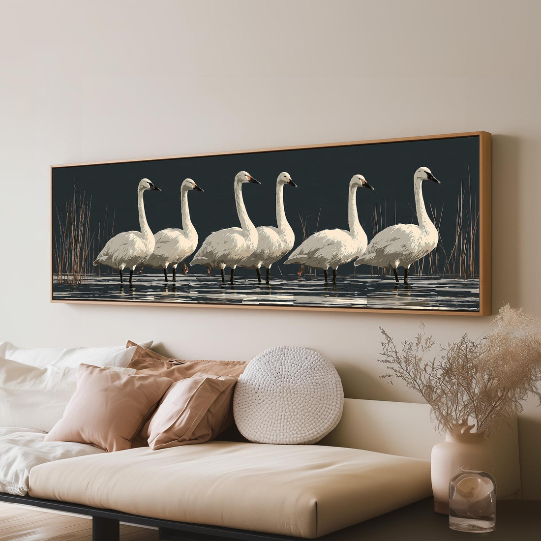 White swans reflected on a dark lake long horizontal canvas print above a sofa in a living room