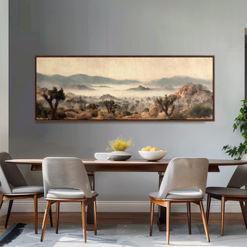 a dining room with a large painting of a desert landscape hanging on the wall above a wooden dining table with four chairs. The painting depicts a serene desert scene with mountains in the background.