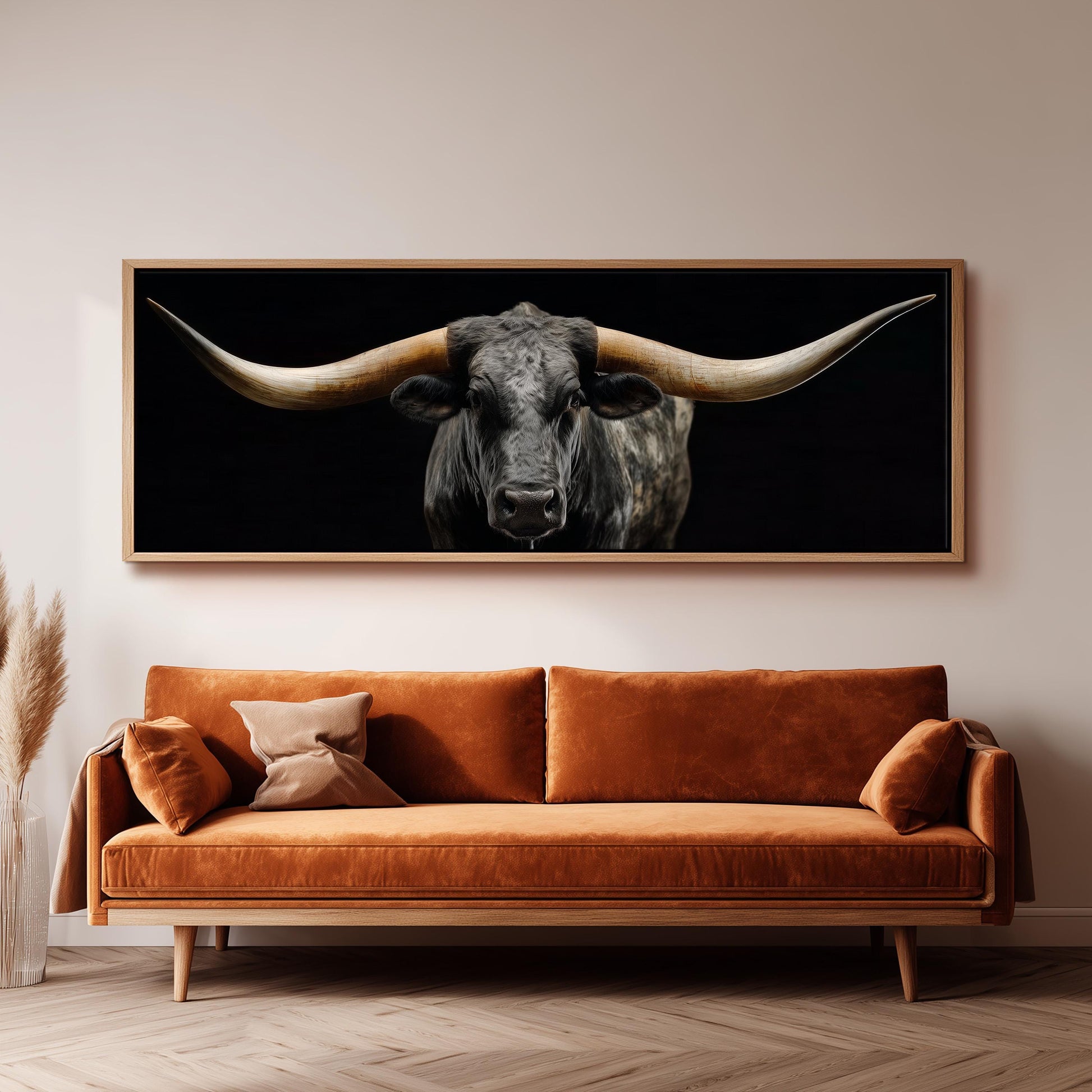 a large black bull with long horns, which is the central focus of the scene. The bull is positioned in the center of the image, with its horns prominently displayed. The bull is set against a dark background, creating a striking contrast with its black fur. The bull's horns are clearly visible, adding to the dramatic effect of the image. The bull is the only object in the image, making it the focal point of the scene.