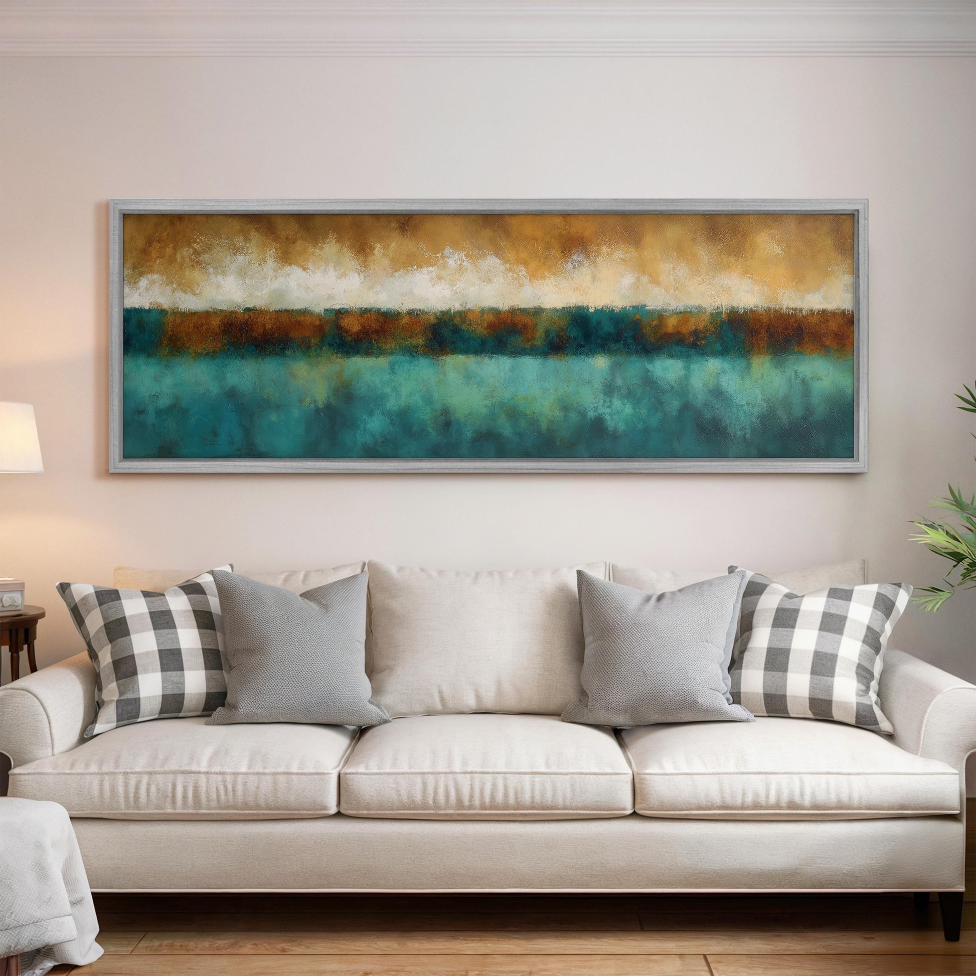 a large, colorful painting hanging on a wall above a white couch with gray and white plaid throw pillows.