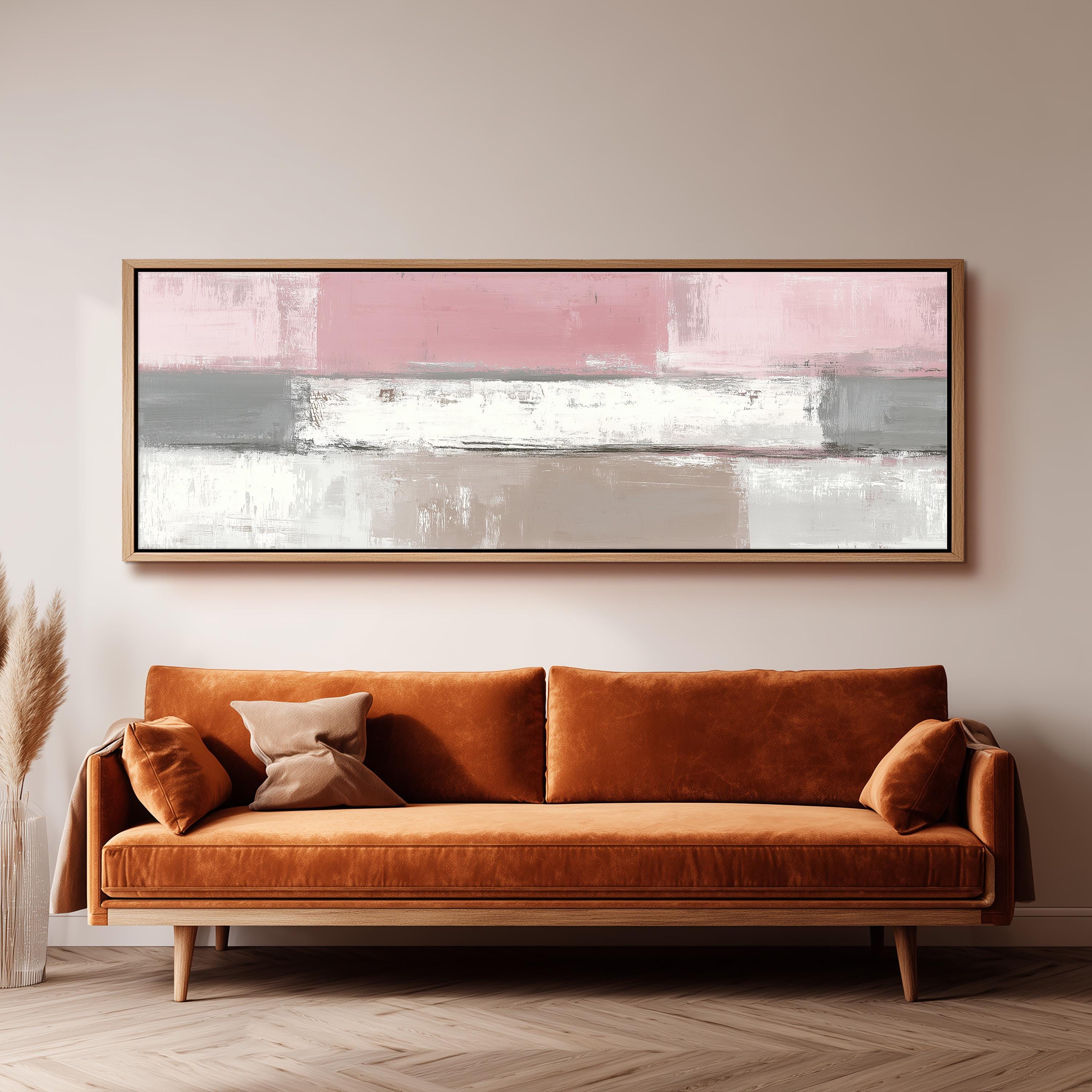 a large abstract painting hanging on a wall above a brown sofa with two pillows.
