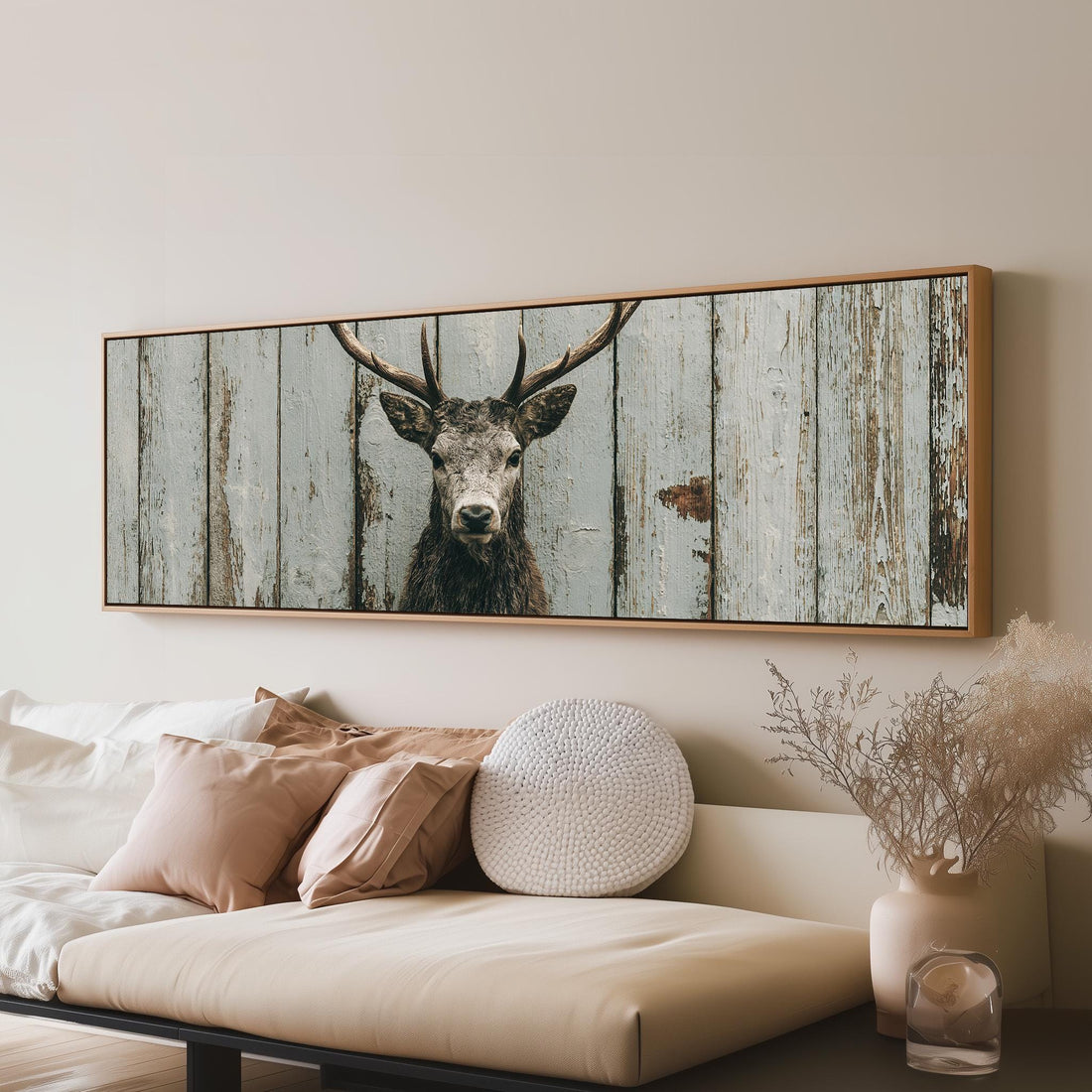 Monochrome stag on barn wood long horizontal canvas print above a sofa in a living room
