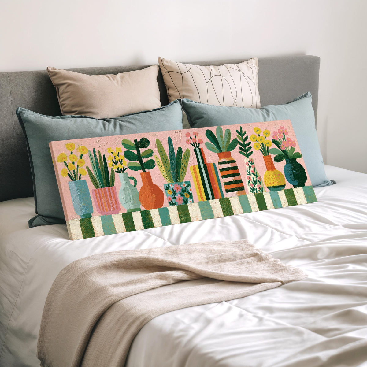 Row of boho potted plants wide panoramic canvas print laid on a bed to show its size