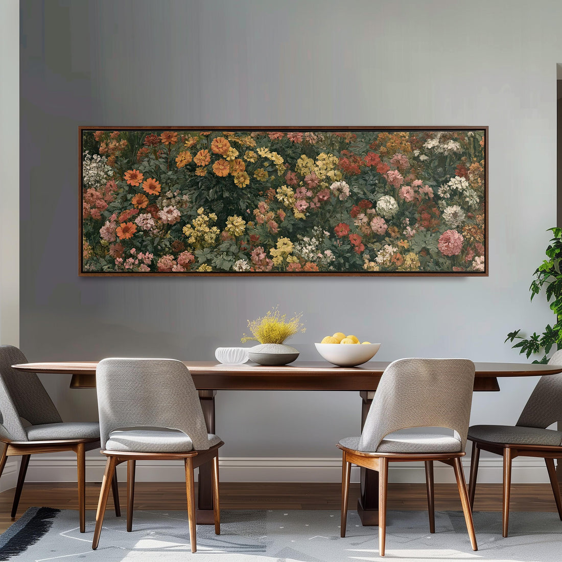 a dining room with a large floral painting hanging on the wall above a wooden table with four chairs. The table is set with a bowl of fruit and a vase of flowers, creating a cozy and inviting atmosphere.