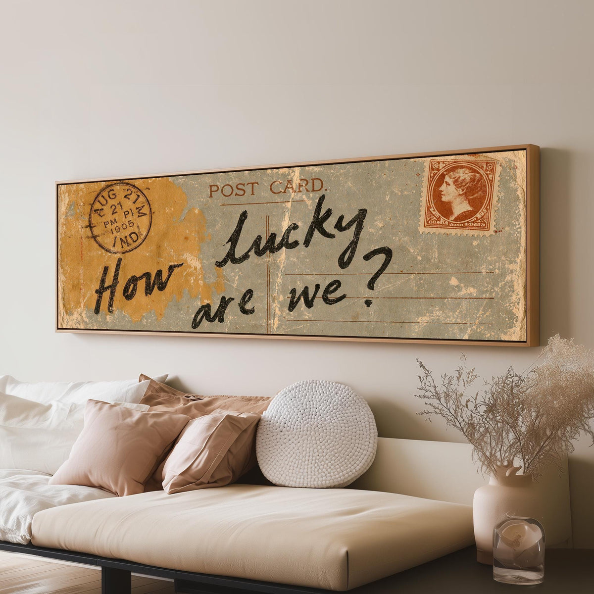 Vintage postcard saying how lucky are we long horizontal canvas print above a sofa in a living room