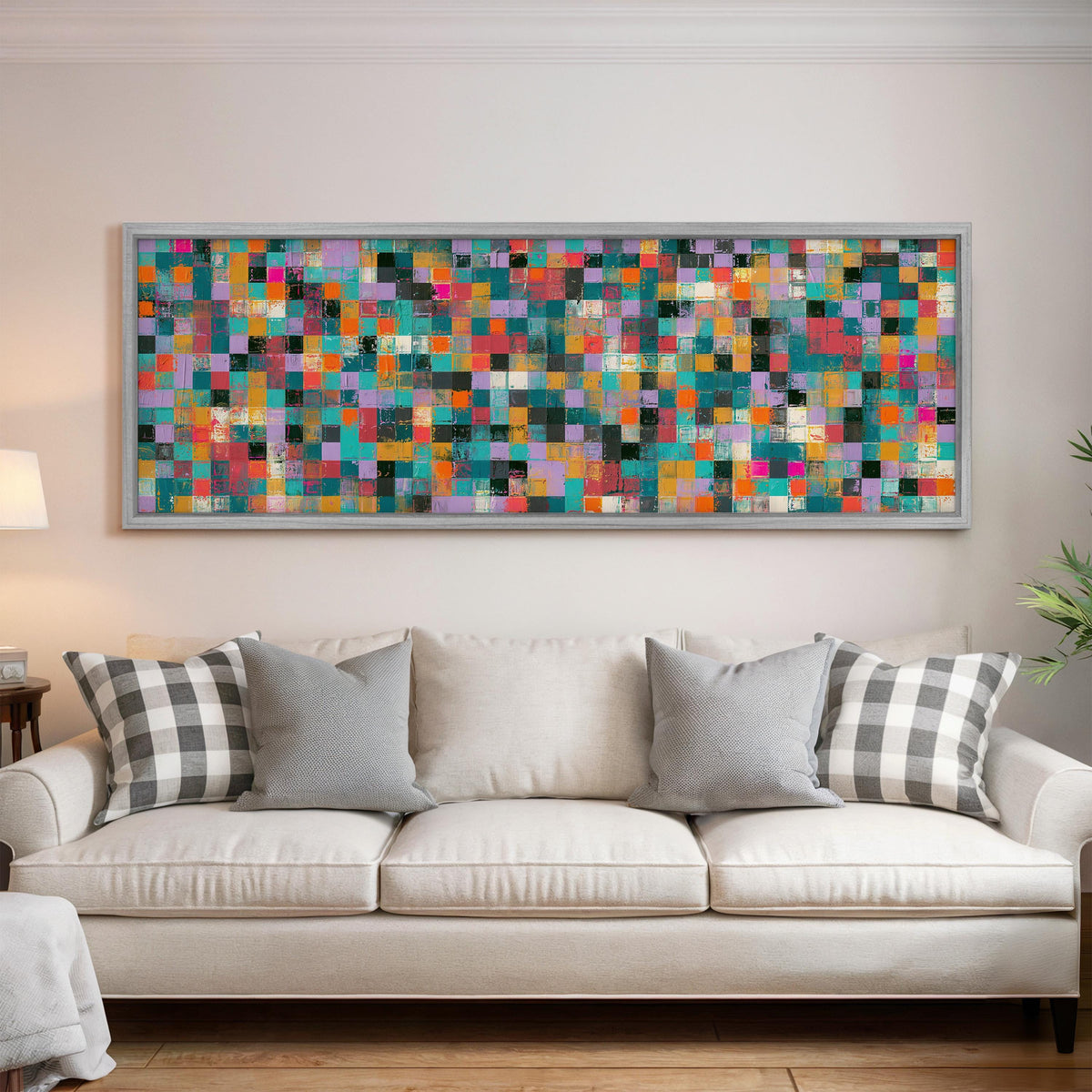 Jewel tone checker mosaic panoramic canvas print above a white sofa in a bright living room