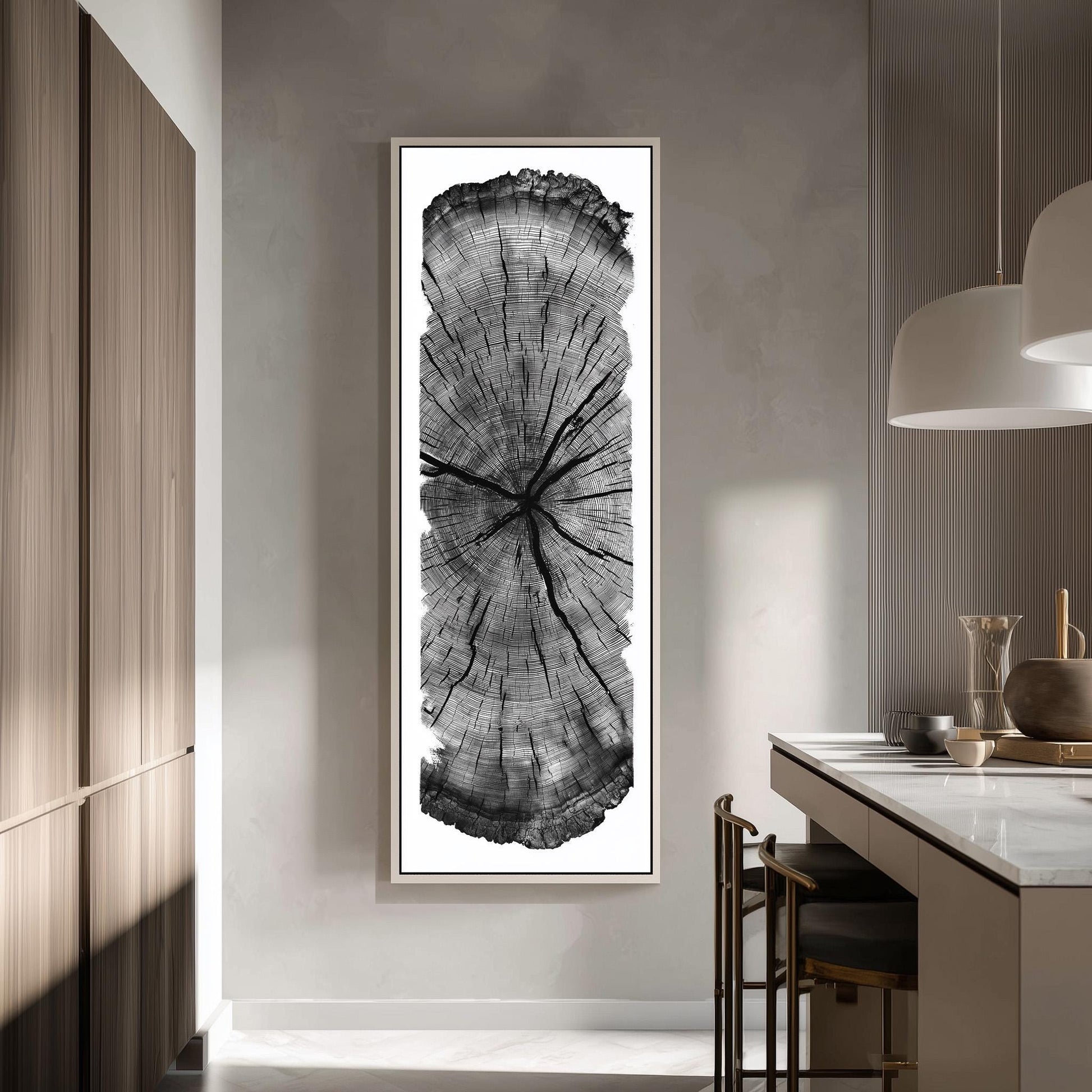 a large, framed black and white photograph of a tree trunk, which is mounted on the wall in a modern kitchen setting.