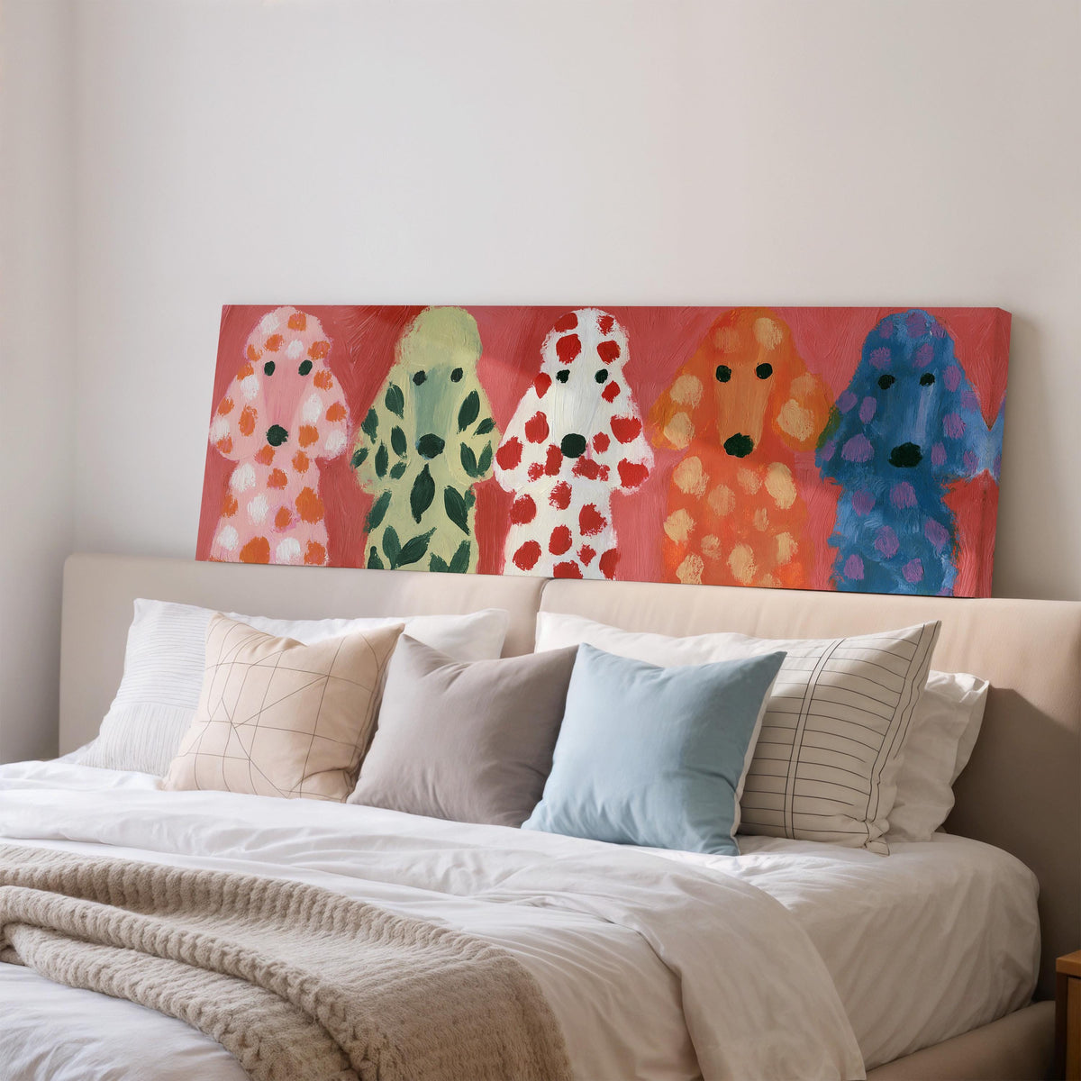 Five colorful poodles wide panoramic canvas print above a bed in a bedroom