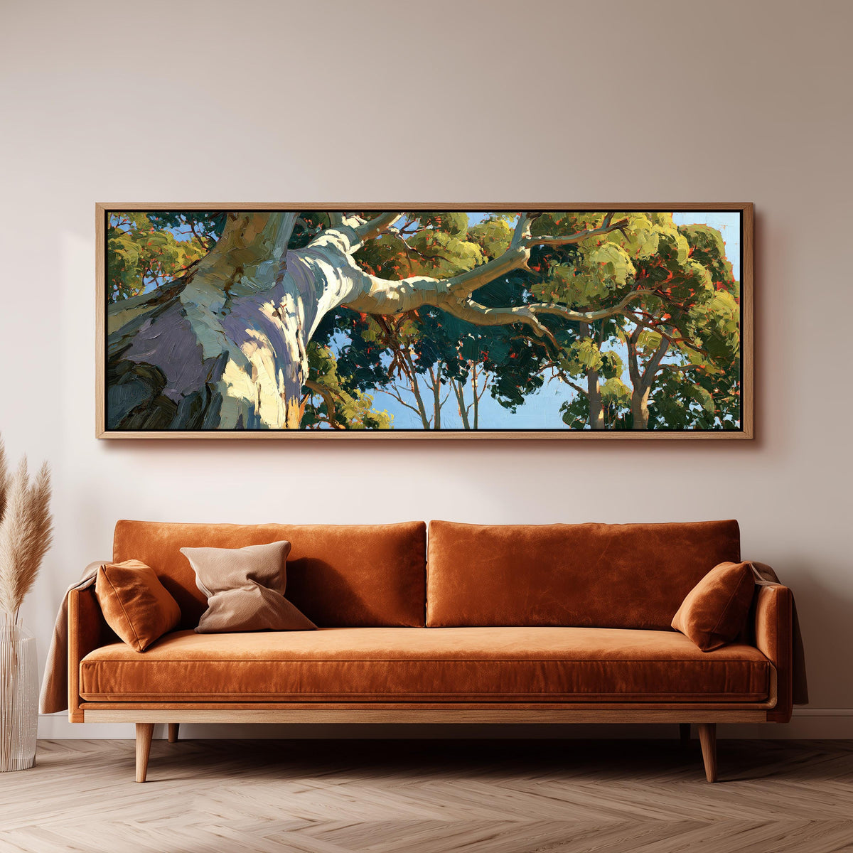 Sunlit eucalyptus trunk and branches long horizontal canvas print above a sofa in a living room