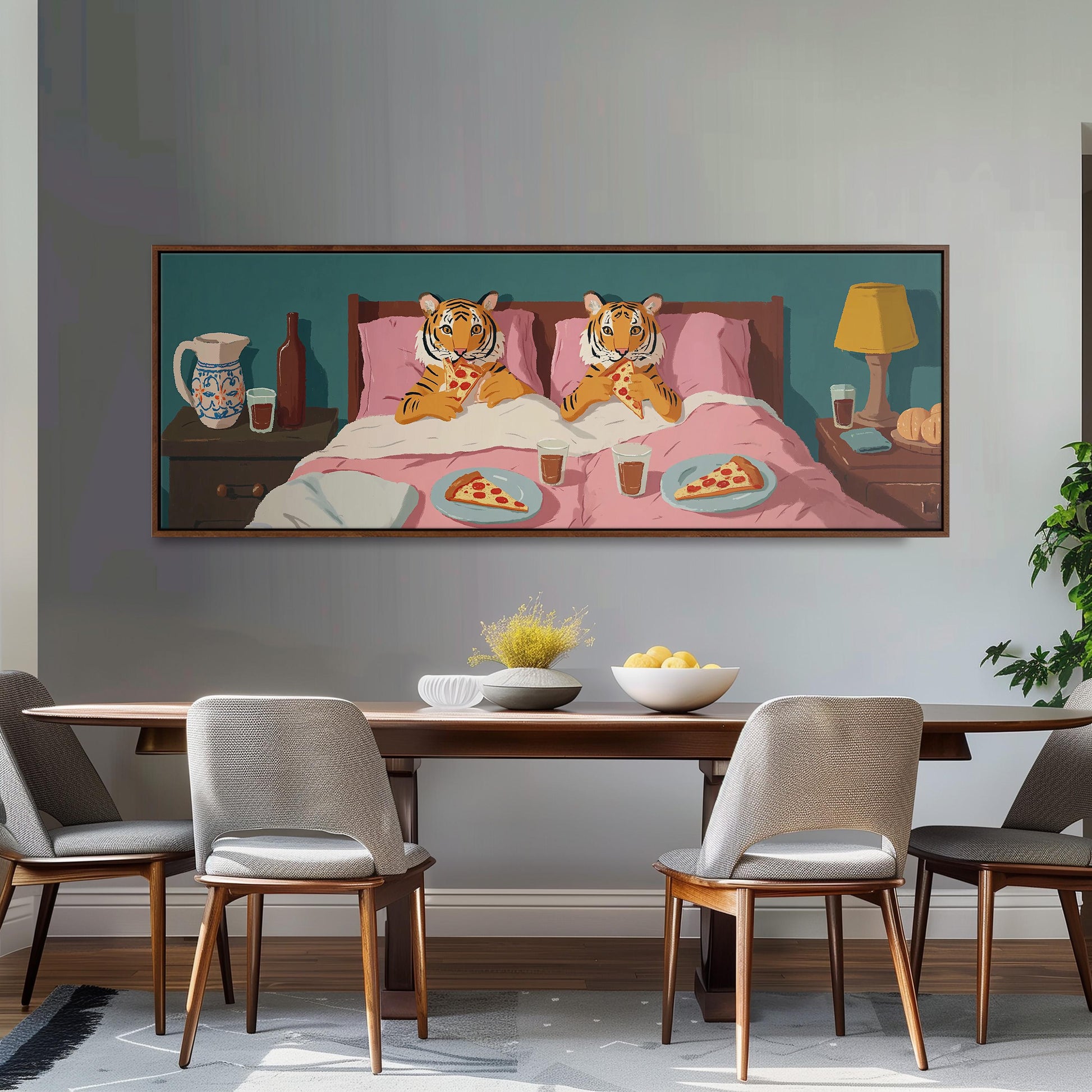 a large painting of two tiger cubs sitting in bed, eating pizza, with a bowl of fruit and a lamp nearby.