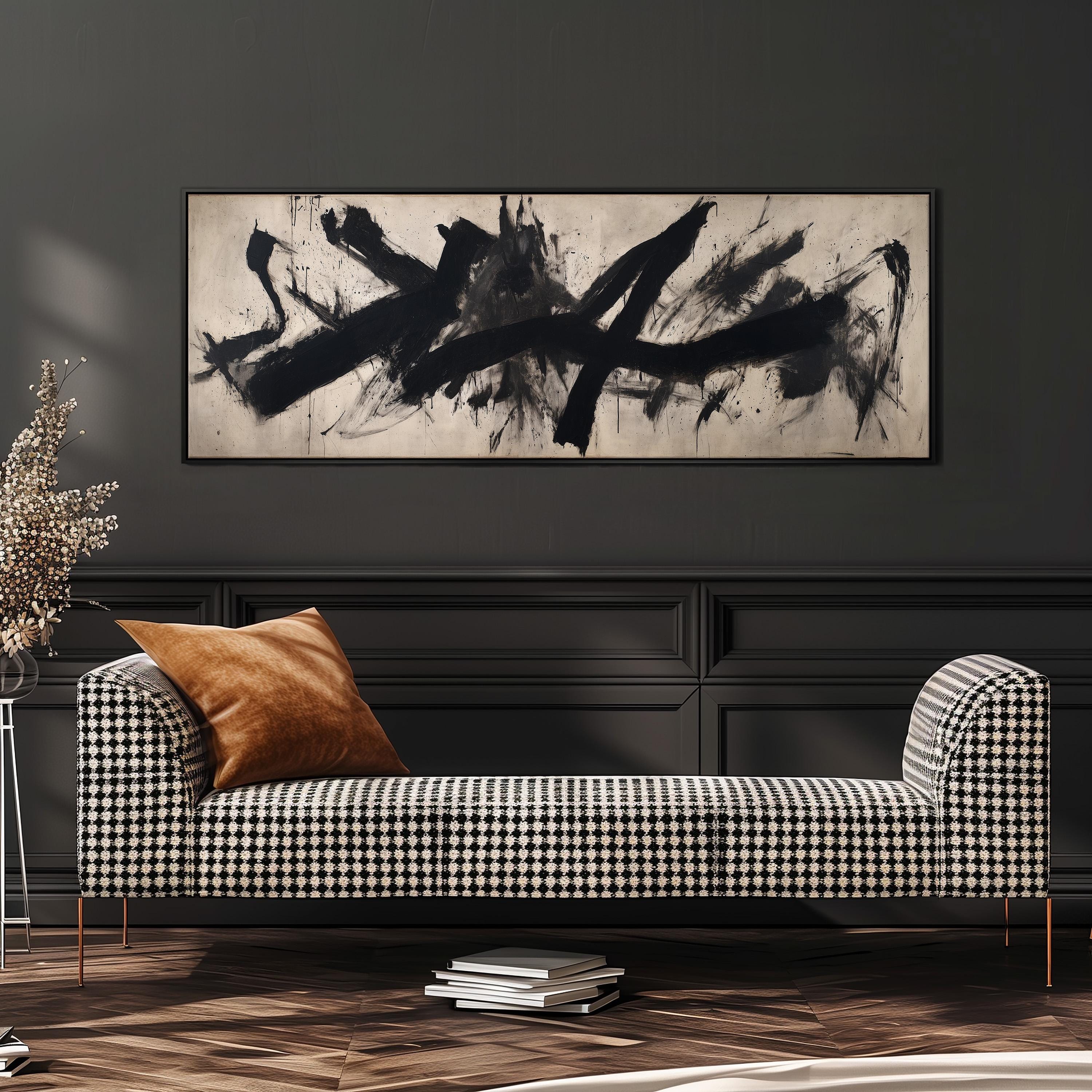 a black and white checkered sofa with a brown throw pillow, set against a dark wall with a large abstract painting hanging above it.