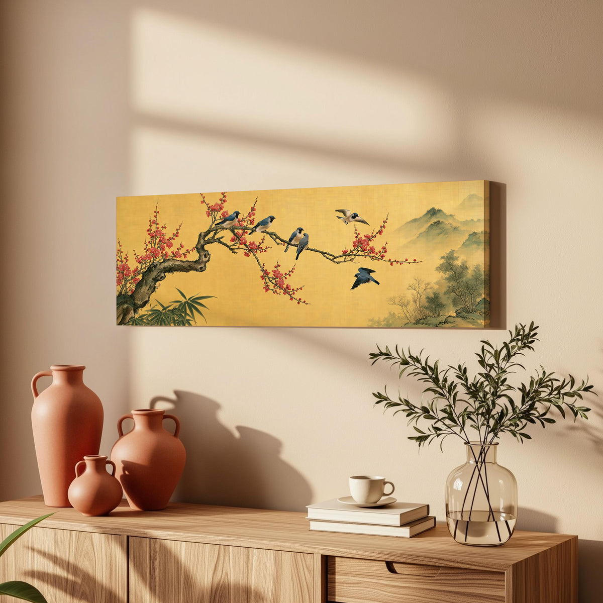 Birds on a plum blossom branch on gold long horizontal canvas print above a wooden sideboard