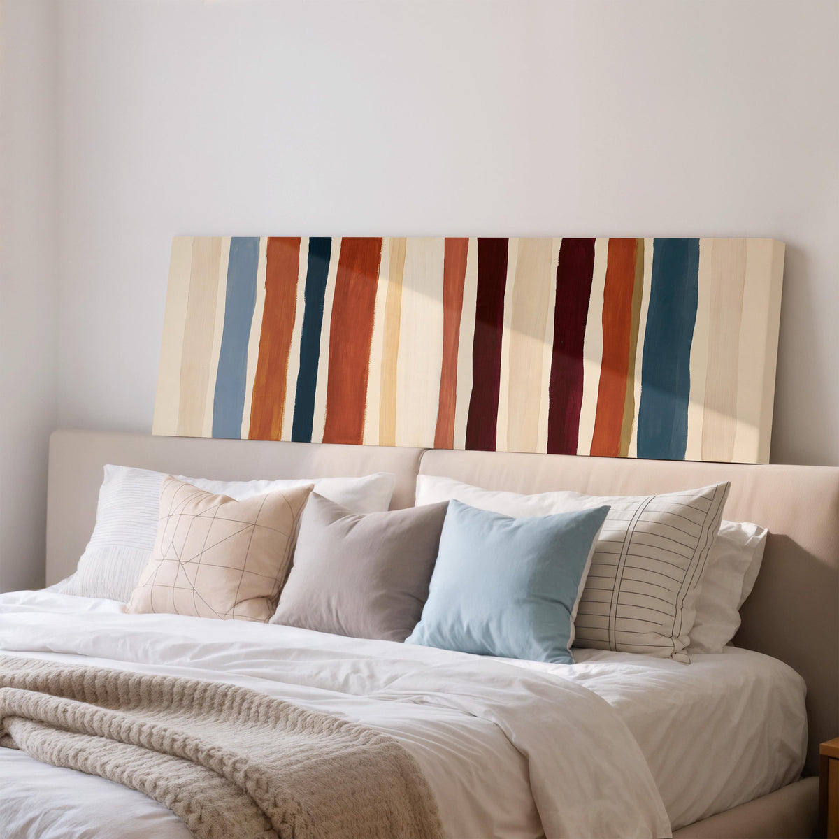 Rust, navy and maroon stripes wide panoramic canvas print above a bed in a bedroom