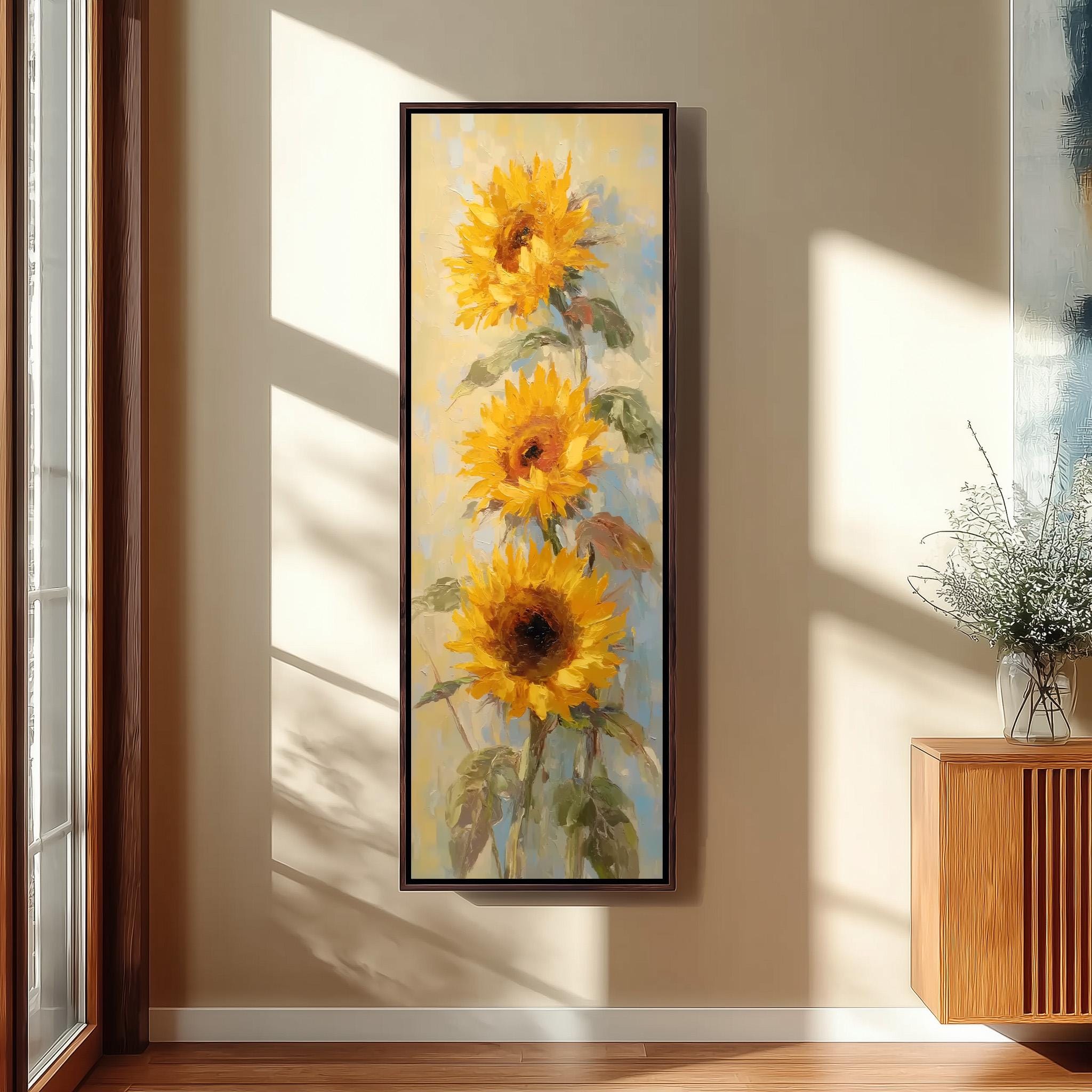 a large painting of three vibrant yellow sunflowers hanging on a wall.