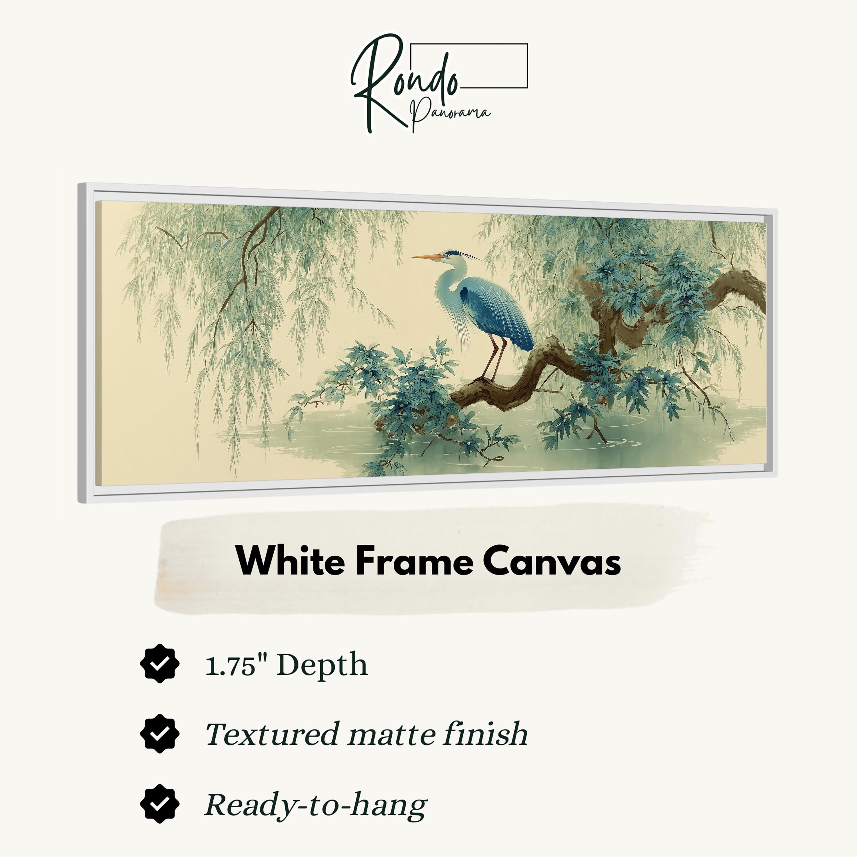 The image is a framed artwork depicting a blue heron perched on a branch with green foliage. The artwork is described as a "White Frame Canvas" with a 1.75" depth, a "Textured matte finish", and "Ready-to-hang".