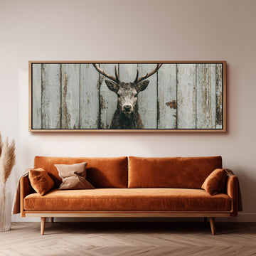 Monochrome stag on barn wood long horizontal canvas print above a sofa in a living room
