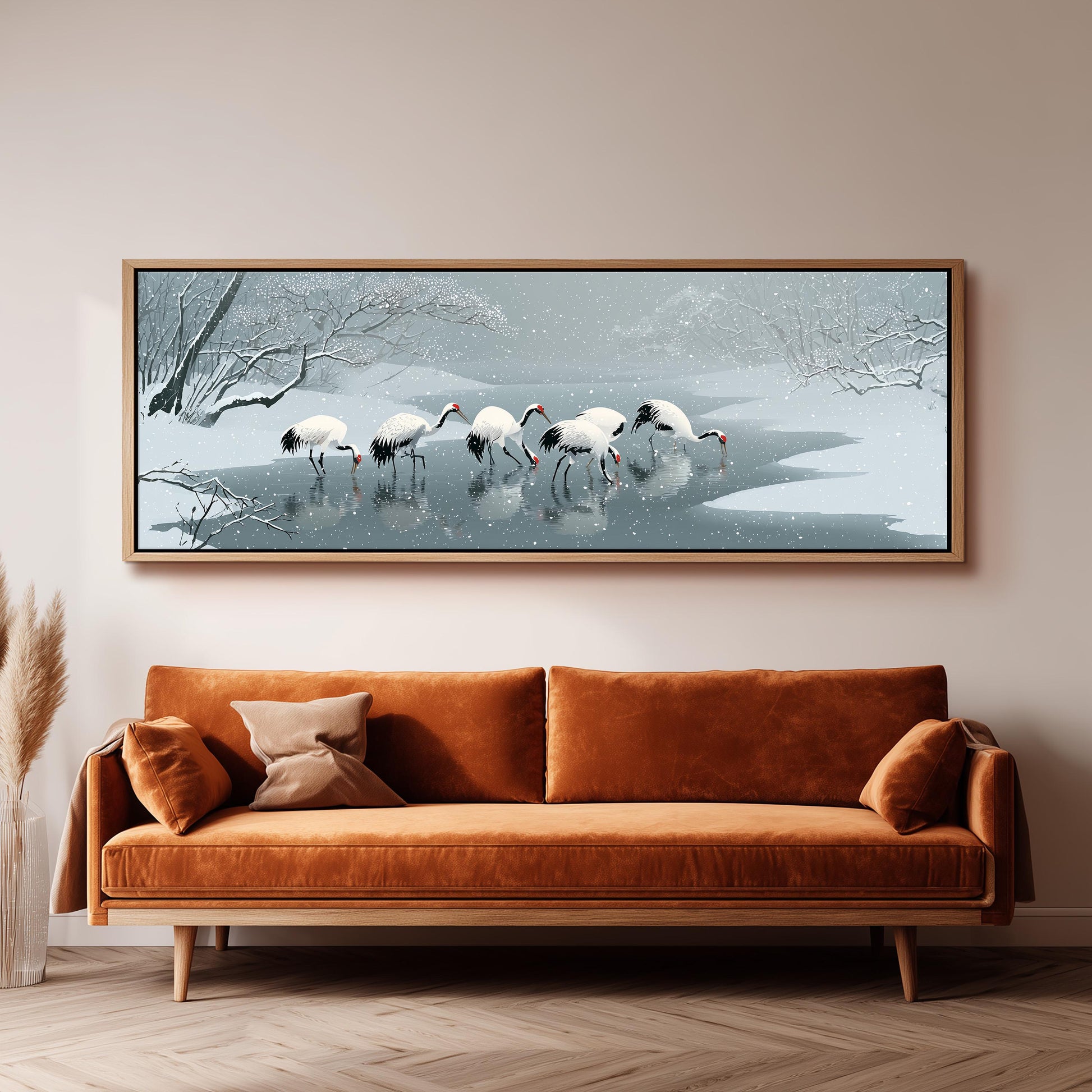 a large, framed painting of a snowy landscape with a group of white birds standing in the water.