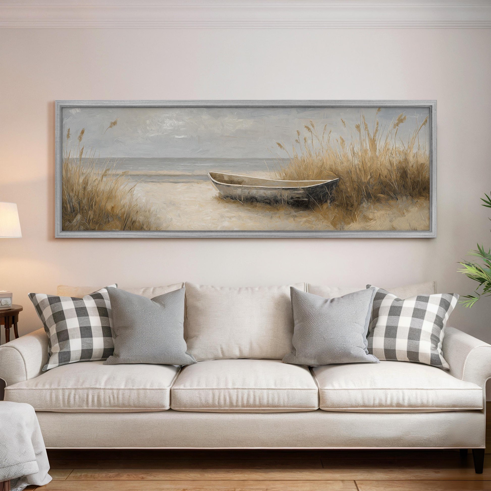 a large painting of a boat on the wall above a white sofa with gray and white plaid throw pillows.