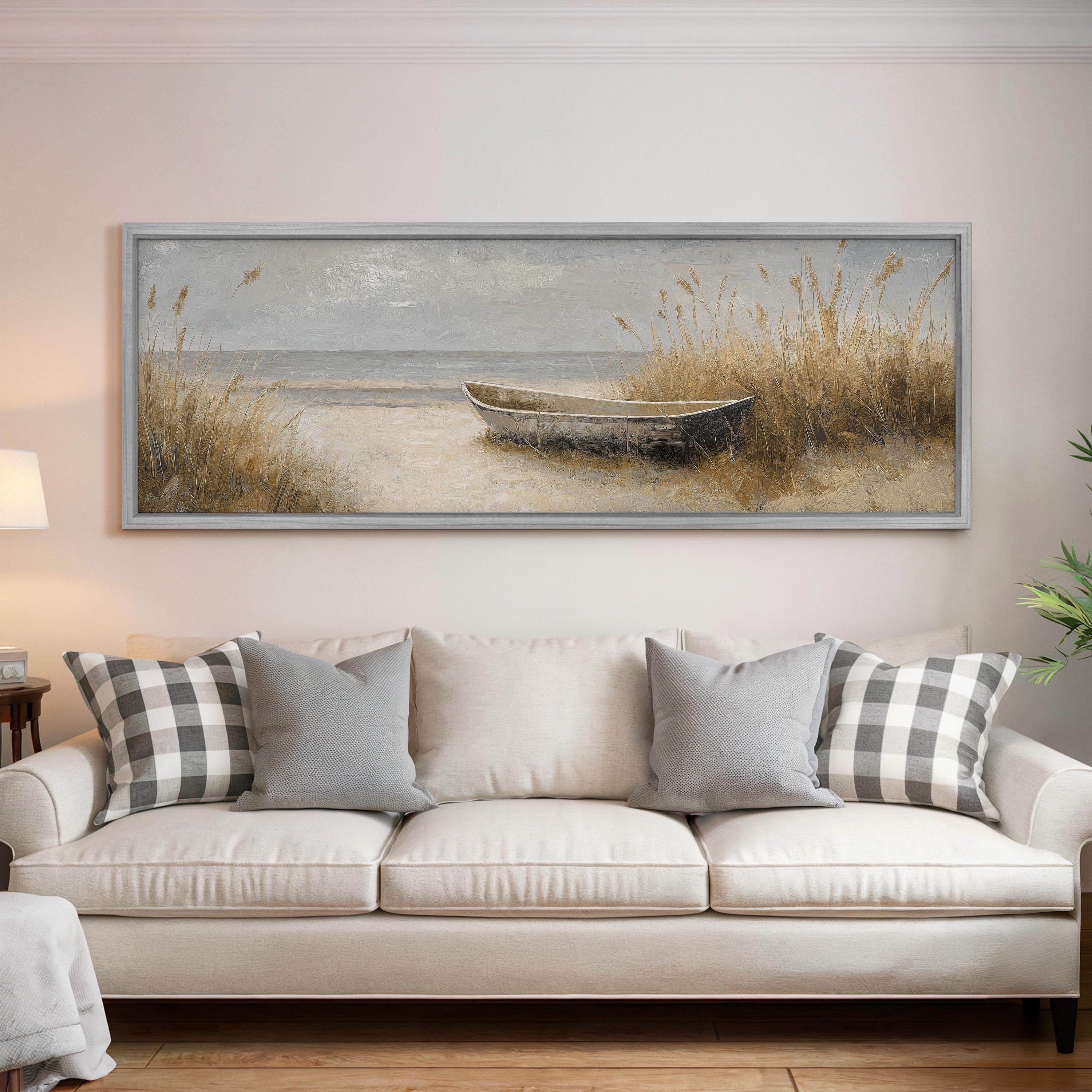a large painting of a boat on the wall above a white sofa with gray and white plaid throw pillows.
