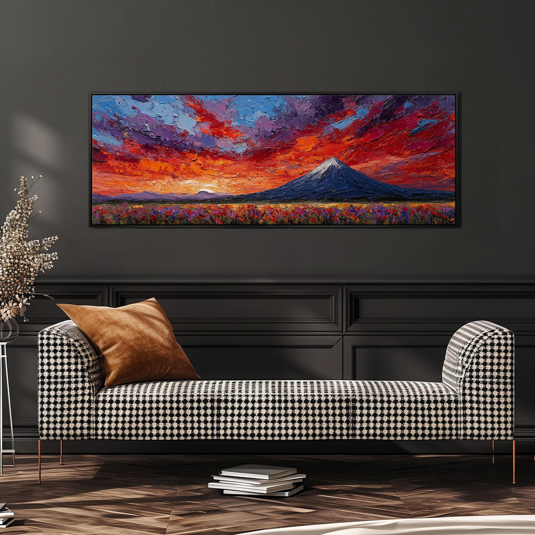 a large, vibrant painting of a mountain landscape hanging on a wall above a brown sofa.