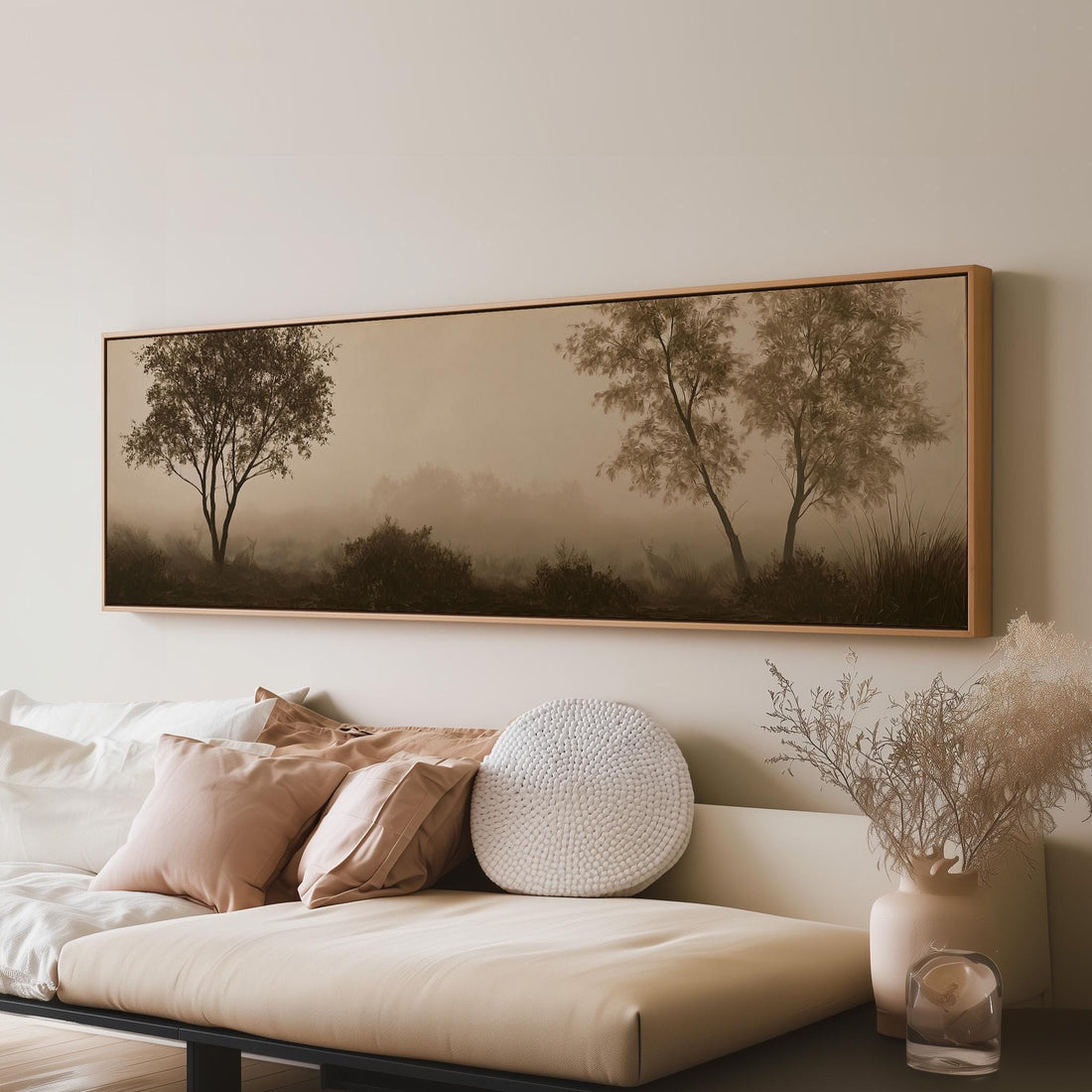 Two trees in sepia fog long horizontal canvas print above a sofa in a living room