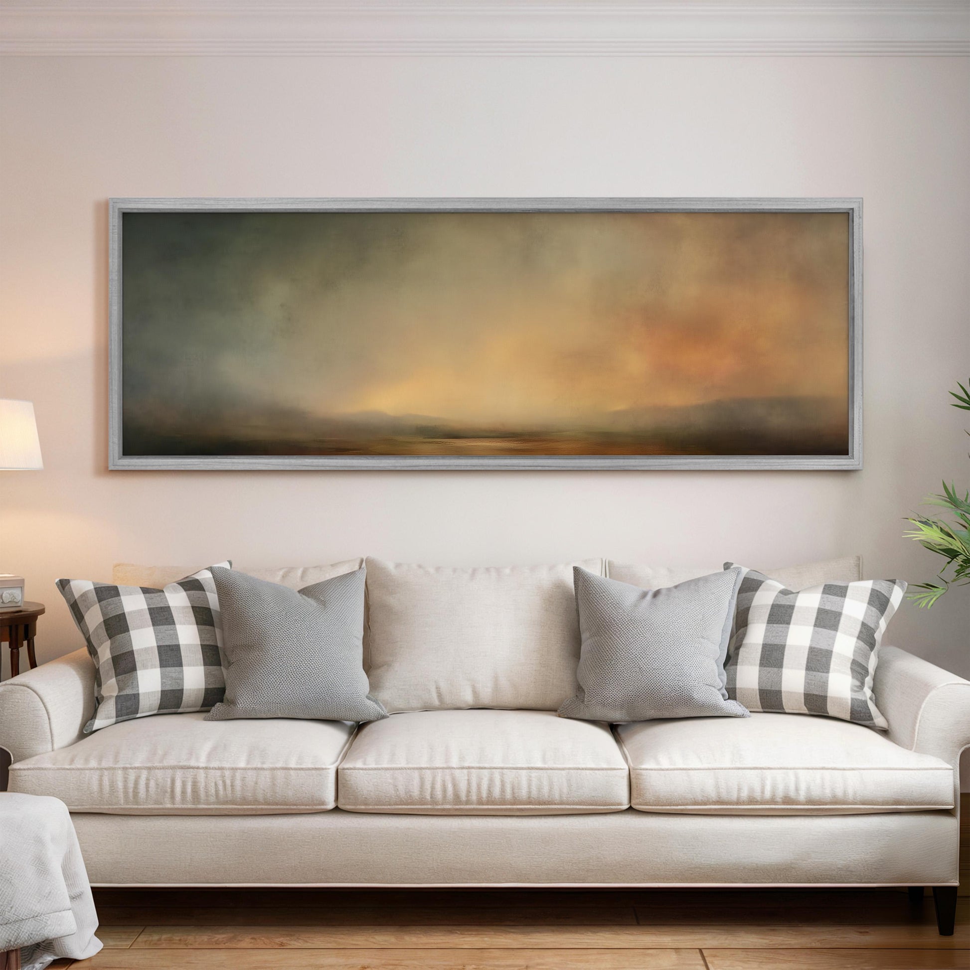 a large, rectangular painting hanging on a white wall above a white sofa with gray and white plaid throw pillows.