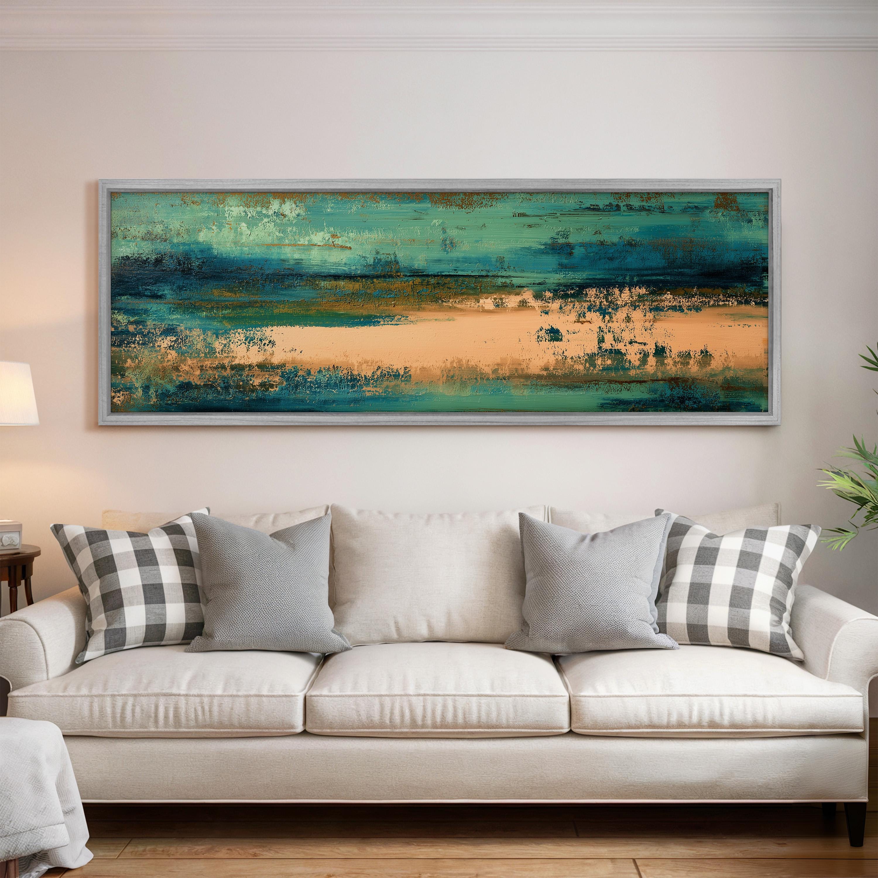 a large, colorful abstract painting hanging on a wall above a white couch with gray and white patterned pillows.