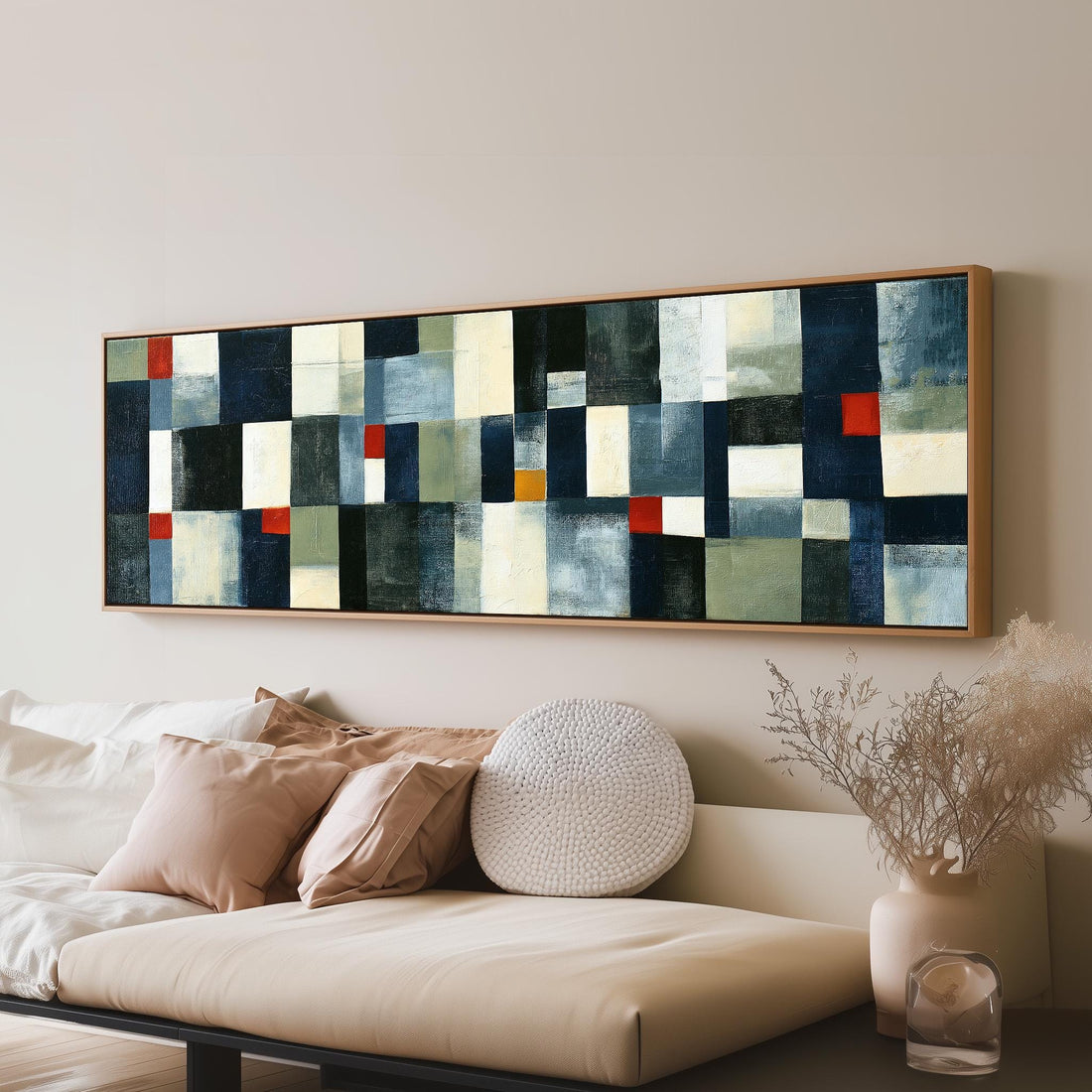 Navy, cream and red patchwork grid long horizontal canvas print above a sofa in a living room