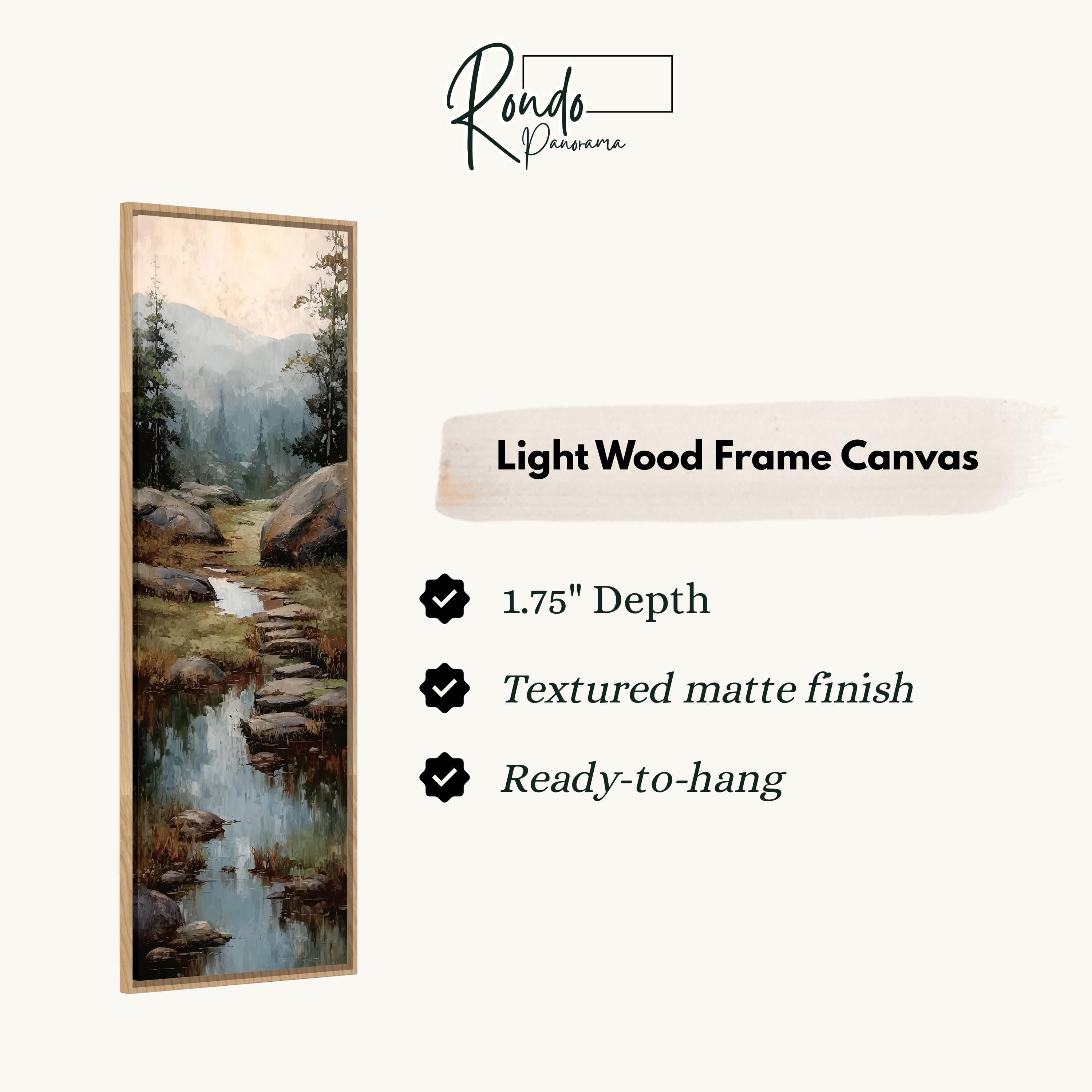 The image is a light wood frame canvas depicting a serene landscape with a stream and mountains in the background.