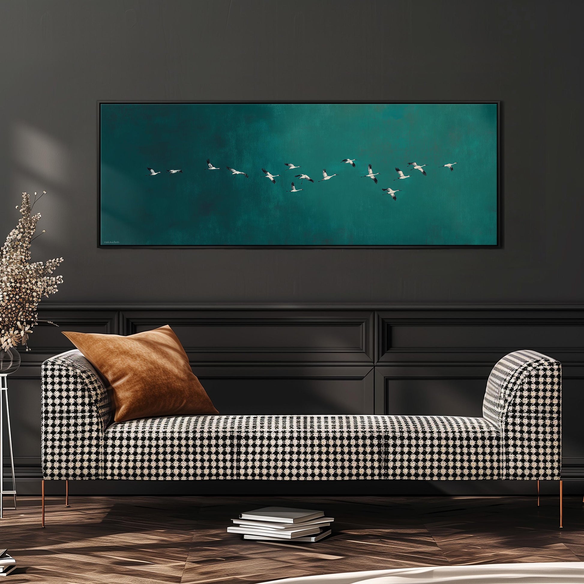 a black and white checkered sofa with a brown throw pillow, positioned in front of a large framed artwork depicting a flock of birds flying over a turquoise background.