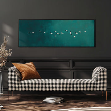 a black and white checkered sofa with a brown throw pillow, positioned in front of a large framed artwork depicting a flock of birds flying over a turquoise background.