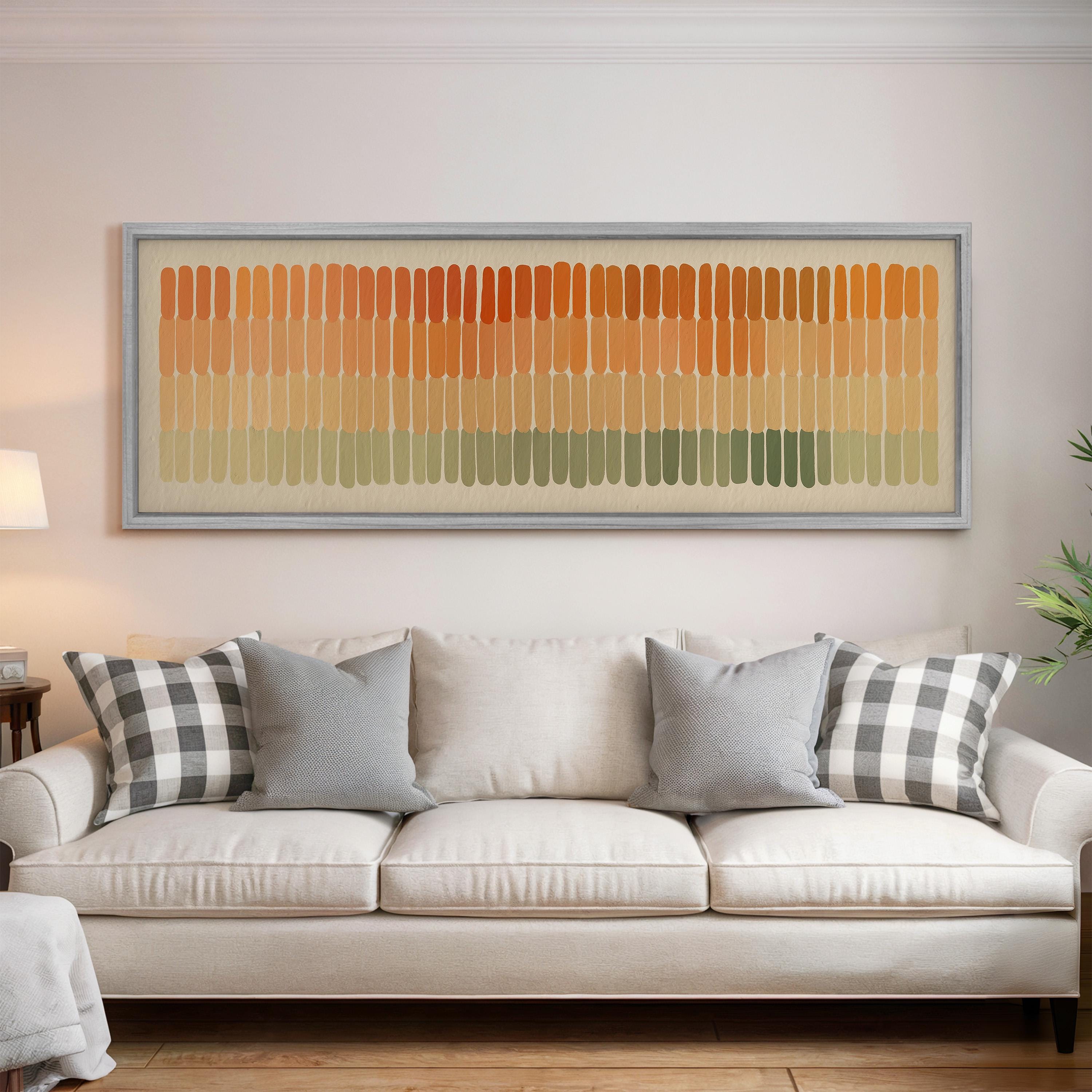 a living room with a white sofa and a large abstract painting hanging above it.