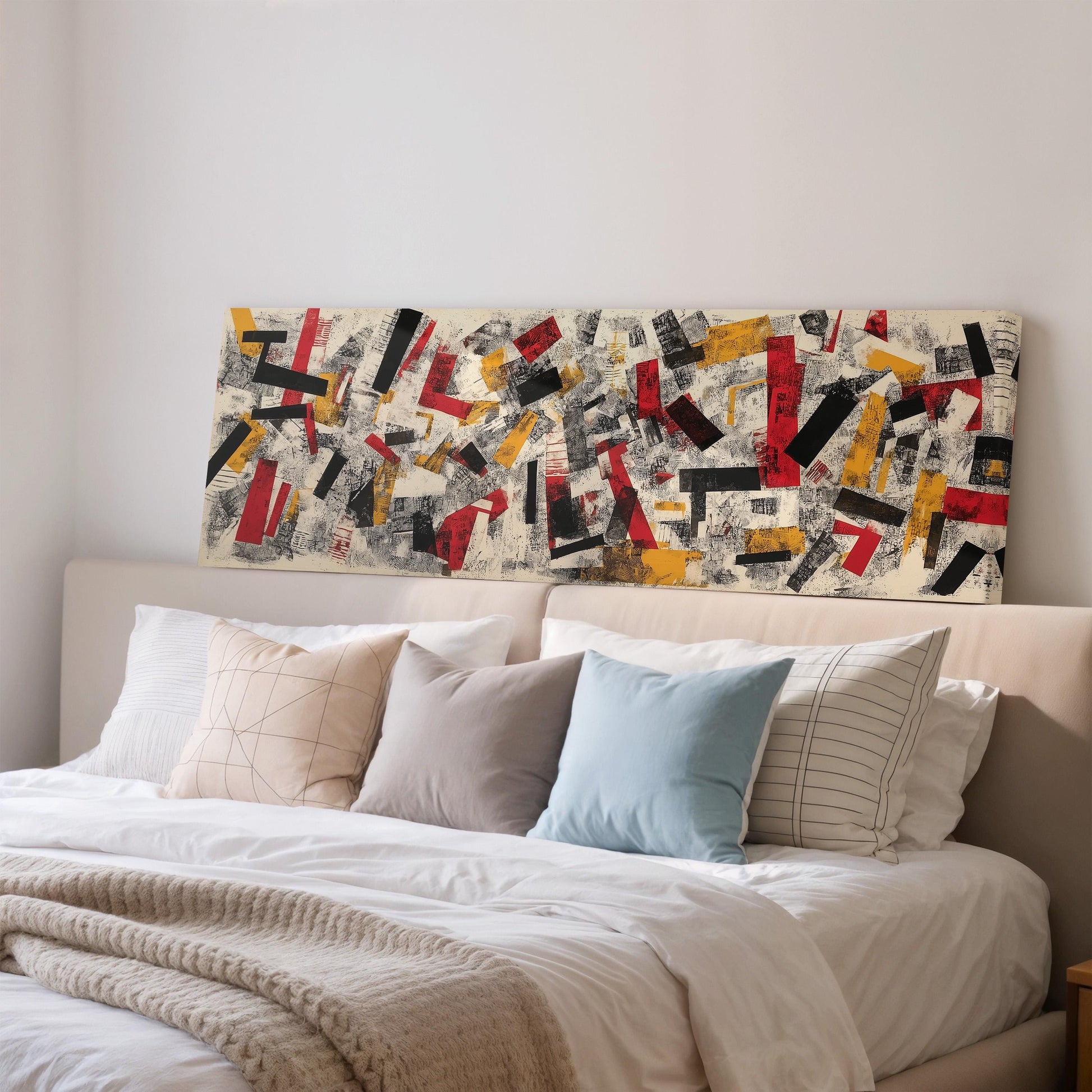a large abstract painting hanging on a wall above a bed with white bedding and pillows.