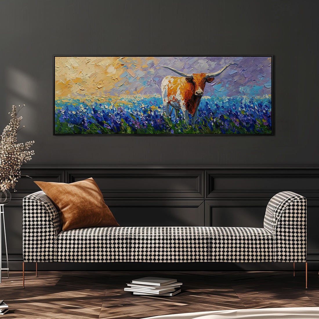 a large painting of a cow in a field of flowers hanging on a wall above a brown sofa.