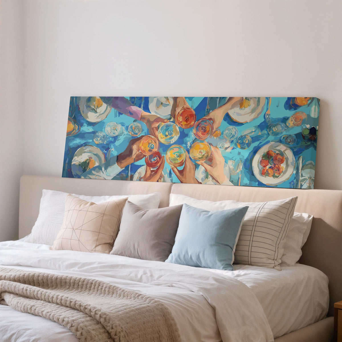 Friends toasting over a blue table from above wide panoramic canvas print above a bed in a bedroom