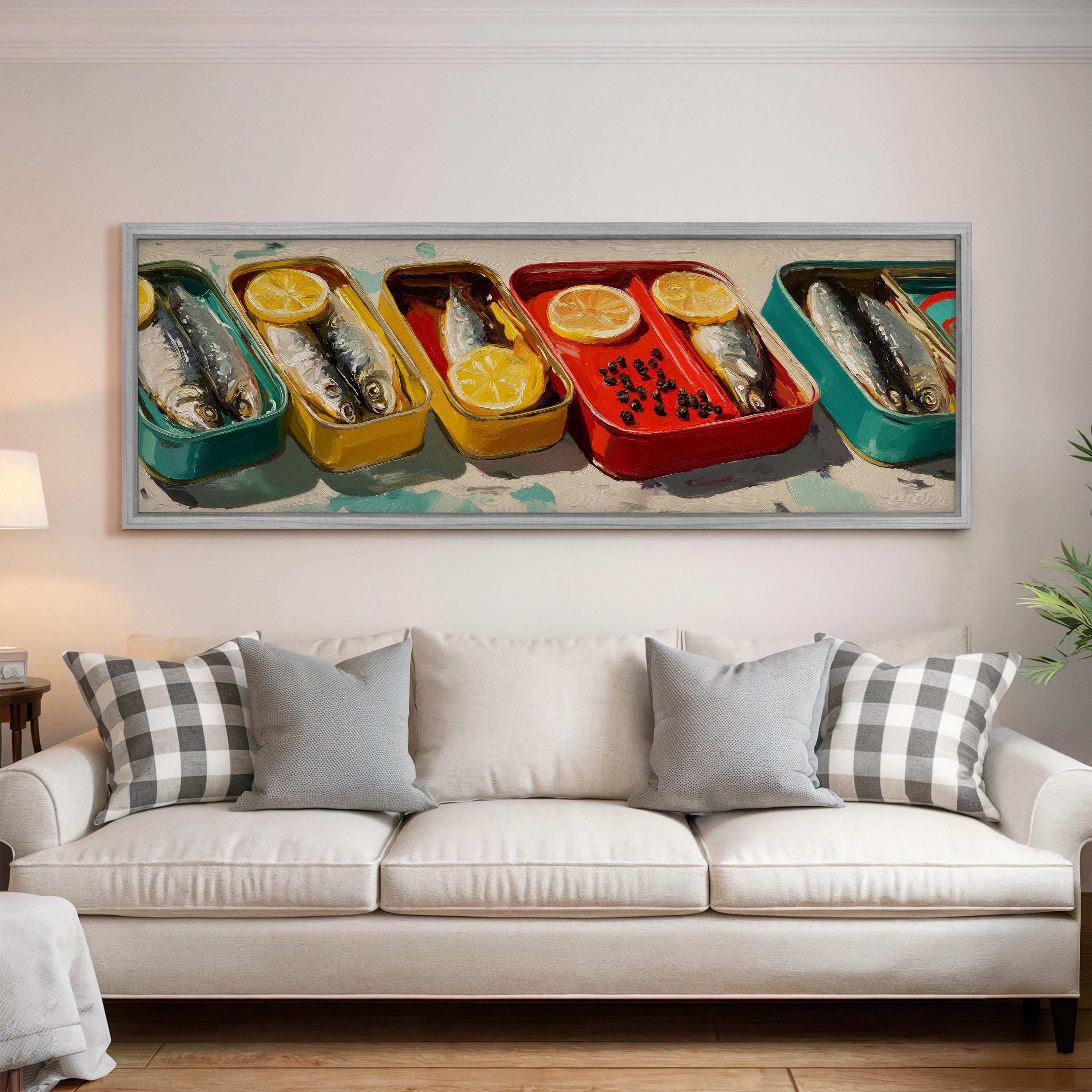 a large framed painting hanging on a wall above a white couch with gray and white plaid throw pillows.