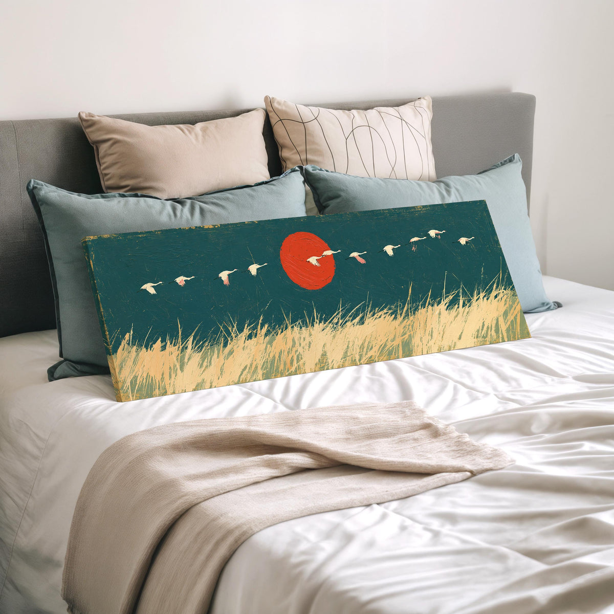 Bird flock over a prairie under a red sun wide panoramic canvas print laid on a bed to show its size