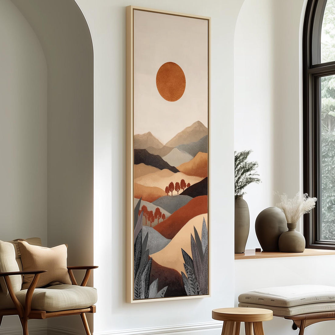 a large, colorful painting of a landscape with mountains and a sun in the background, hanging on a wall in a room with a window and seating area.
