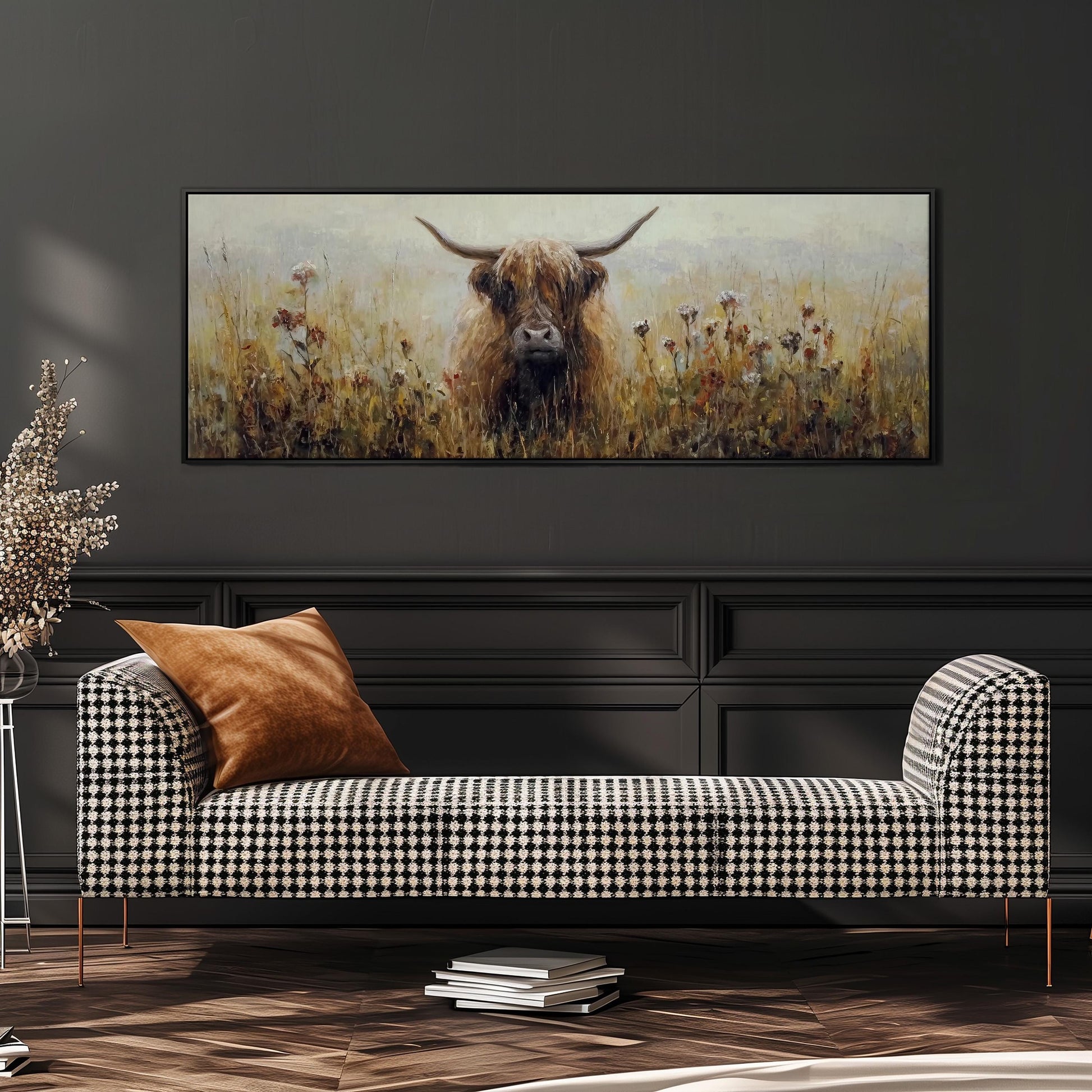a large painting of a cow with horns, displayed on a wall above a black and white checkered sofa.