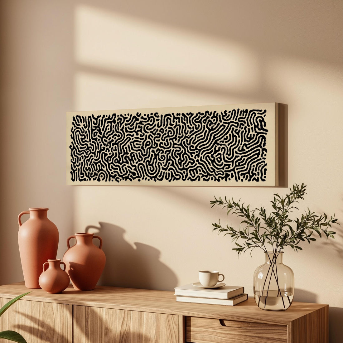 a wooden cabinet with a vase, a plant, and a framed abstract artwork on the wall above it.