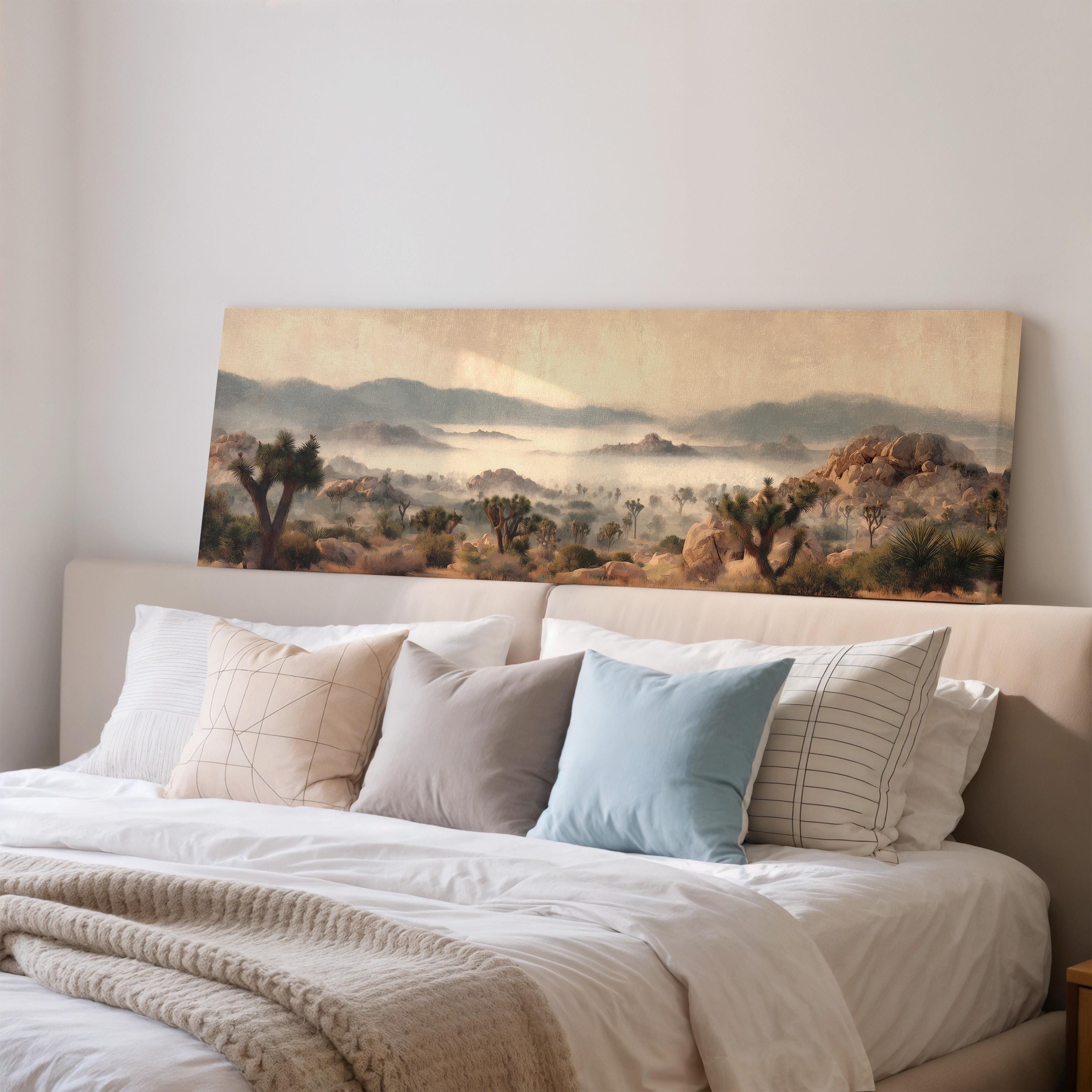 a large landscape painting hanging on a wall above a bed with white bedding and pillows.