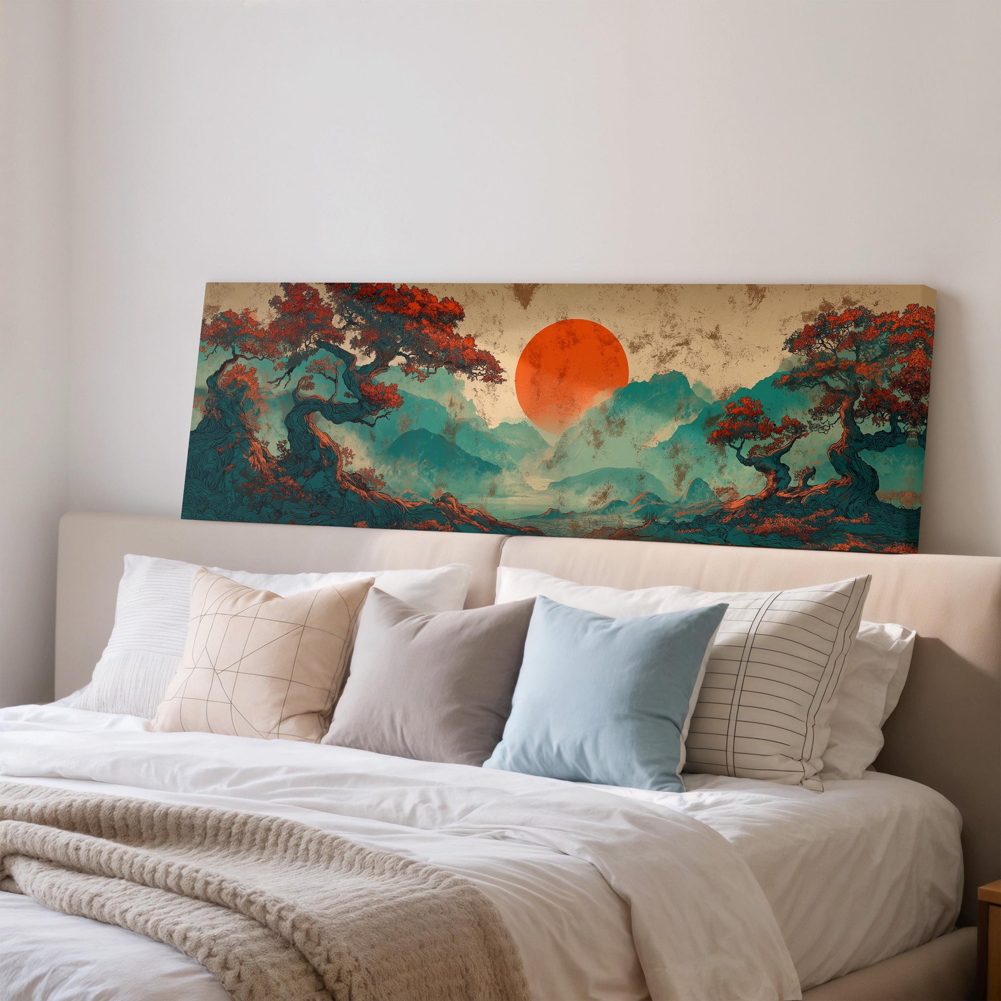 a large, colorful painting of a landscape with a sun in the background, hanging on a wall above a bed with white pillows and a gray blanket.